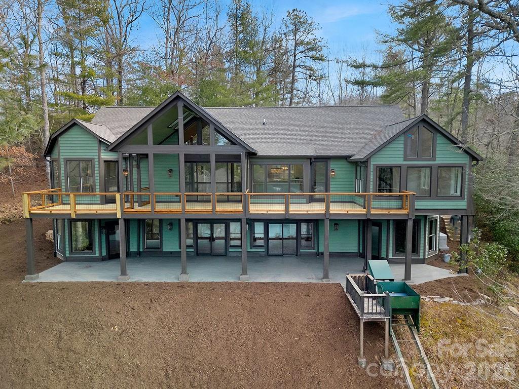 This stunning home on lake Atagahi has just undergone an extensive custom remodel. The spacious house has year-round lake and mountain views. The main level living includes split floor plan with open kitchen and dining area overlooking the lake. You will be in awe of the exquisite details. A massive stone fireplace, built-ins, GE Cafe appliances, granite, custom cabinets, gorgeous wood floors, and the list goes on and on. All bedrooms are large with vaulted ceilings. The huge screened in porch is perfect for entertaining and taking in the natural surroundings. Large Decks and a covered patio are great for outdoor activities. The attached 2 car garage and laundry are on main level. The lower-level ha an expansive billiards room, full bath, bedroom, bonus room, and a great workshop/storage room. There is a powered tram for easy access to the dock and waterfront. You'll enjoy breathtaking sunsets and all of the amenities that Connestee Falls has to offer! This one is truly a MUST SEE!
