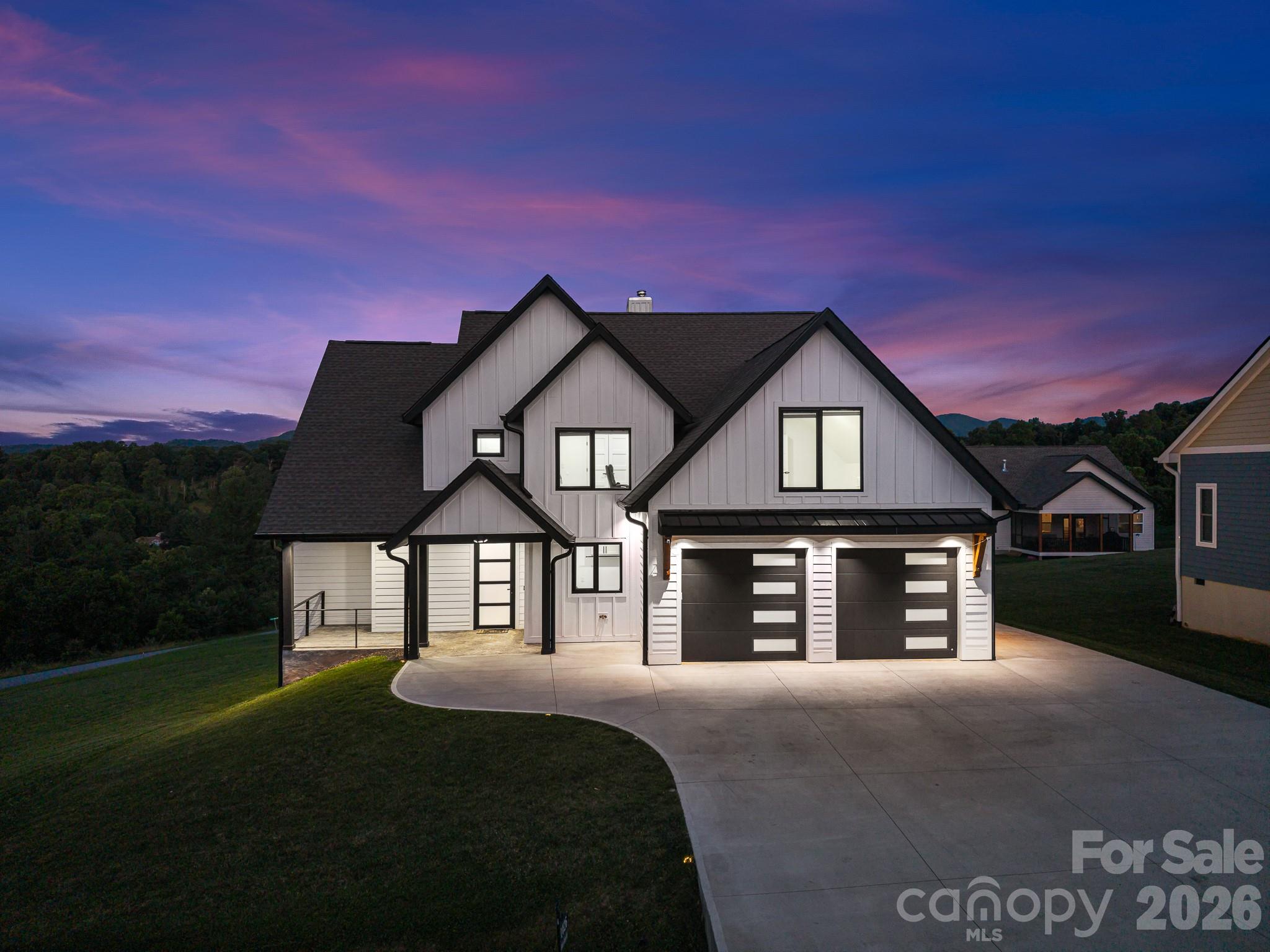 Welcome to this beautiful luxury home in Candler, offering the perfect blend of modern elegance, mountain living, and convenient access to Asheville. Located approximately 15 minutes from downtown Asheville, this exceptional property provides easy access to local dining, shopping, and everyday amenities while placing you just moments from the natural beauty of Western North Carolina, including the Blue Ridge Parkway and countless hiking opportunities.
Thoughtfully designed across three levels, the home offers expansive, move-in ready living spaces, including a fully finished basement with both interior access and a private exterior entrance. Two luxurious primary suites provide exceptional flexibility and comfort, with one conveniently located on the main level with separate access to porch and the second upstairs featuring a built-in bookshelf and attic stair access to an additional storage space of around 331 sq ft of unfinished attic.
Luxury finishes are showcased throughout, highlighted by vaulted ceilings in the main living area with an open-to-below design that enhances natural light and creates a dramatic sense of space. Oversized contemporary windows with sleek quartz sills further elevate the home, filling each room with natural light and framing stunning mountain views. As well as built-in custom pantry and closets. 
The gourmet kitchen serves as the heart of the home, featuring ceiling-height cabinetry, pot filler, a striking waterfall island, and matching quartz countertops.
The finished basement adds exceptional versatility with a second kitchen, dedicated washer and dryer hookups, and a built-in sauna ideal for guests, multi-generational living, a private retreat, or potential long-term rental opportunities. Two-zone HVAC system. One unit serves the main level and basement; second unit serves the upper level. 
Outdoor living is equally impressive, featuring a spacious main-level deck, a lower-level patio, and a fire pit area perfect for enjoying the peaceful mountain setting. The oversized parking area includes a two-car garage and ample room for additional vehicles.  This neighborhood has a community well, with a back-up well also installed. 
With generously sized windows and rooms, abundant storage, spacious closets, luxurious touches and detailed finishes, this remarkable move-in ready home delivers the comfort, privacy, and craftsmanship expected in a true luxury mountain residence.