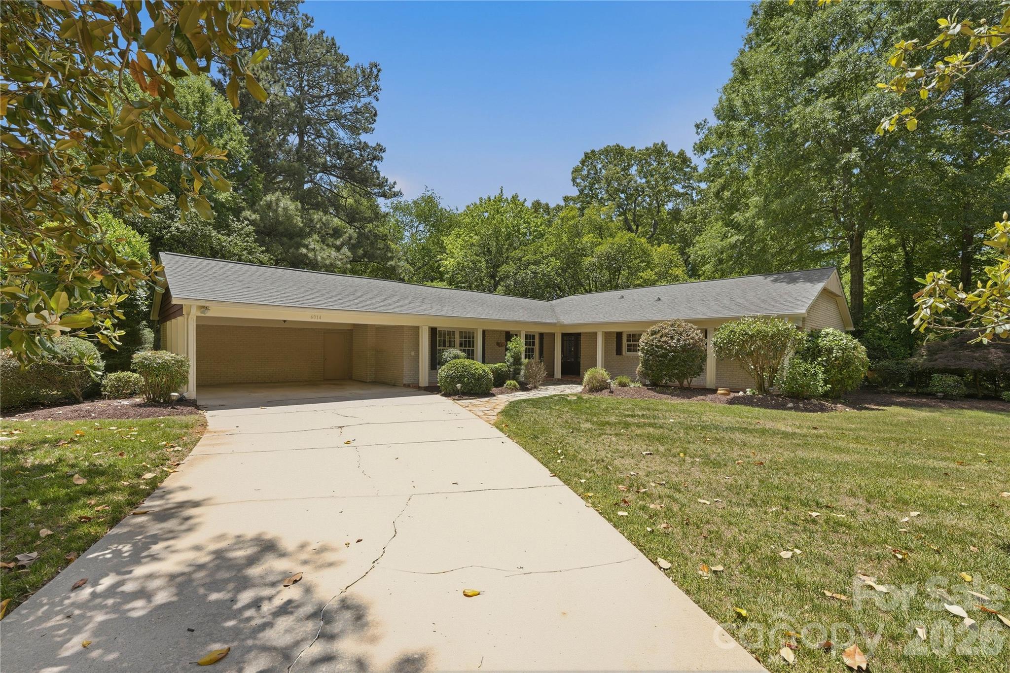 Charming full brick ranch in South Park's coveted Stonehaven community! Classic architecture meets a sophisticated reimagination at 6014 Glenridge Road. Privately positioned on a lush .34 acre lot, this 3 bedroom, 2 bathroom ranch offers a floor plan rarely found in this era--thoughtfully layered living spaces that flow with both character and intention. Inviting L-shaped front porch welcomes you to the curated interior filled with warm spaces and intentional design. Two distinguished living areas each with decorative fireplaces and stunning molding offering you a relaxed and elevated environment. Arched doorways enter you into your intimate dining room perfect for hosting. Gourmet kitchen with quality cabinetry, granite counters and stainless appliances. Desirable flex/office space transitions well off your main living area. French doors open up to your screened porch to enjoy four season Carolina weather overlooking your private lush back yard. Brick paver patio for cool summer night enjoyment. Large 440 SF two car carport with storage room. A rare opportunity for a quality built full brick ranch in one of South Park's most popular communities.