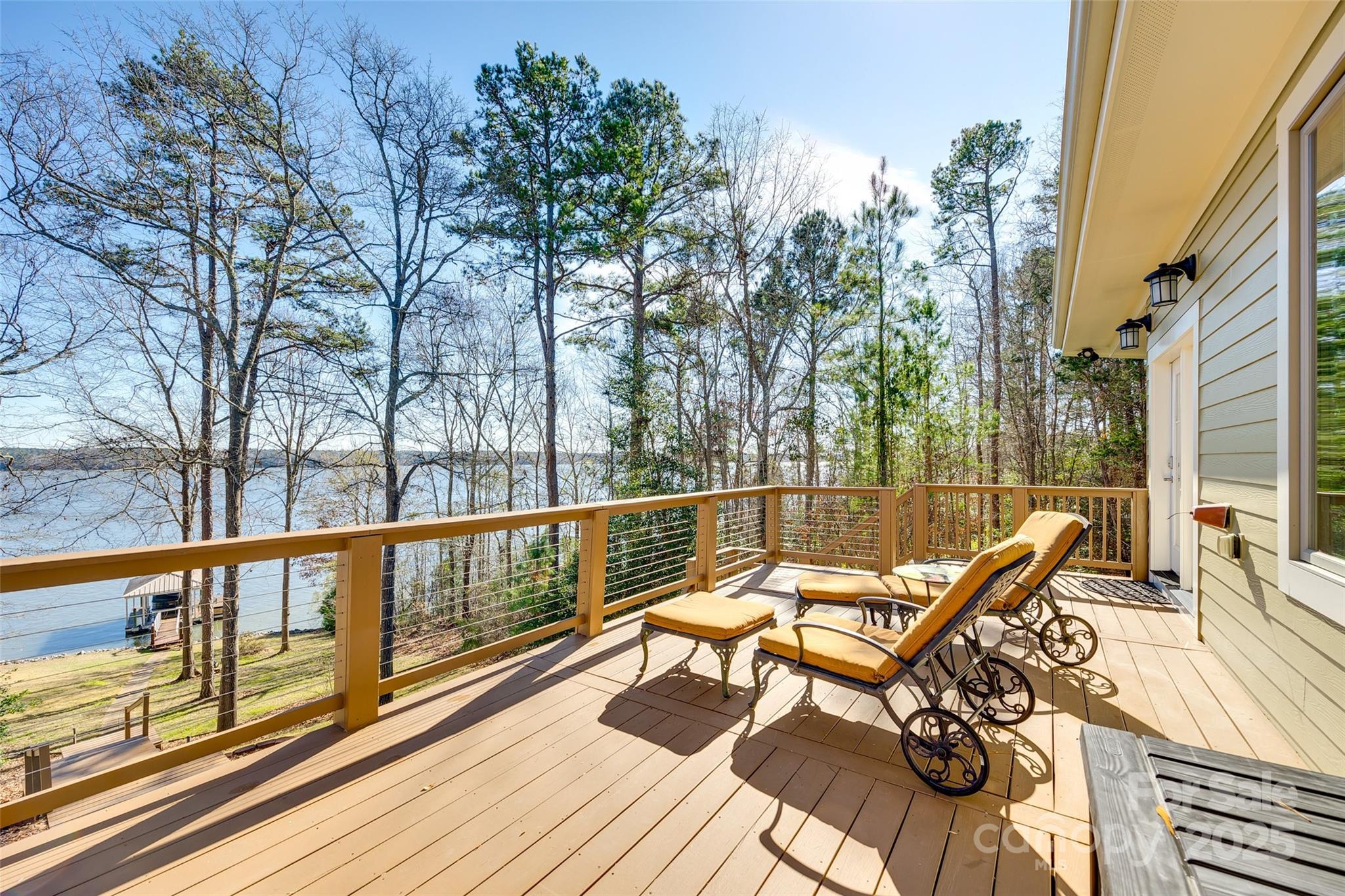 Waterfront luxury at its finest! Enjoy stunning lakefront views year-round from this exquisite Craftsman home with its very own covered dock & boat lift. Leave the chaos behind to escape to the quiet & fun of lake living. This home has plenty of room for family, friends & fun. Panoramic windows create water views, natural light, & the serenity of nature all year. The main floor boasts a luxurious primary suite, gourmet kitchen w/ huge island, walk-in pantry, cozy fireplace, office, laundry room & 2 story great room. The finished basement showcases more water views, a billiard/rec room, full bar, exercise/flex room, heated workshop, full bath & ample storage. Upstairs includes 2 private rooms w/private balconies, a shared jack-&-jill bath & loft area. Built as a 3 bedroom home, the septic system is permitted for 2 BR. This custom lakeside sanctuary offers peace of mind & stress-free living w/ its Geothermal HVAC, metal roof, boat lift, Generac generator & much more.