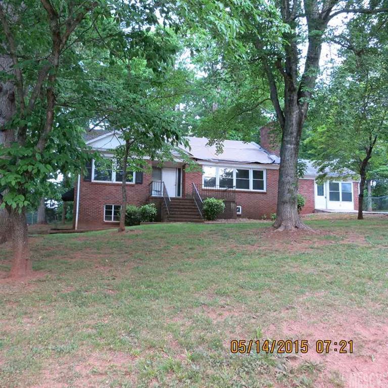 All brick with basement on Conover side street has much potential w/hardwood & tile floors.  3 full baths (one in basement), LR w/FP, Formal DR.  Unsure of basement HVAC.
