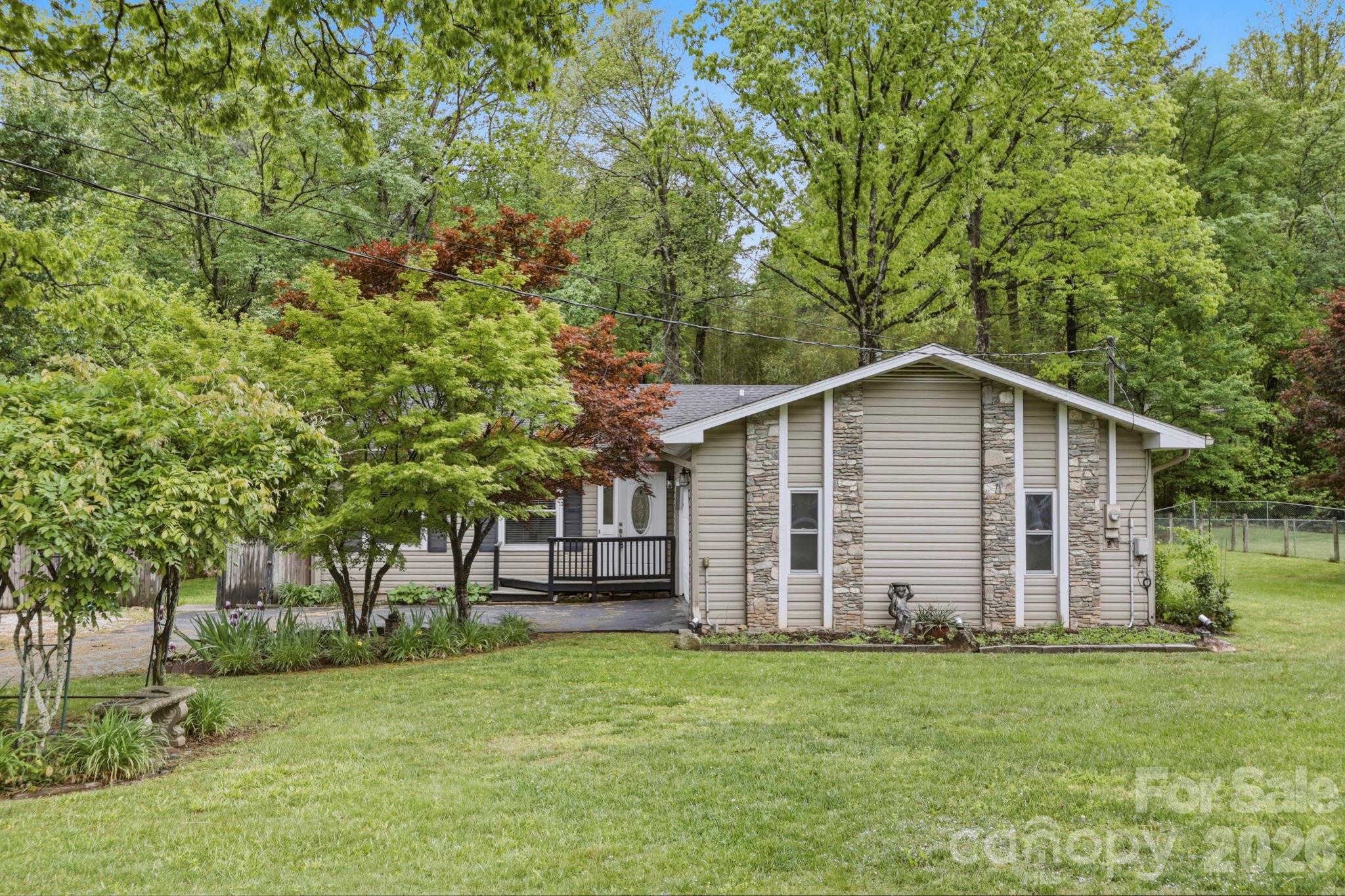 MOTIVATED SELLER!  With an acceptable offer, seller agrees to give a $10,000 credit to buyer at closing for interest rate buy down, closing costs or home improvements.  Lovely, well maintained one level ranch style home.  Situated on a picturesque .47 acre level lot. The floor plan offers 3 bedrooms and 2 full bathrooms.  Lovely hardwood floors throughout the main house.  Den was added onto the house and it has laminated flooring.  Conveniently located to shopping, entertainment, churches and schools.  Centrally located to many points of interest in Western North Carolina.  Many nice updates include granite countertops, stainless appliances, and a spacious pantry in the kitchen.  Large laundry room with lots of storage space.  Outbuilding conveys.  Older established neighborhood with well-maintained homes.  Schedule your showing today!