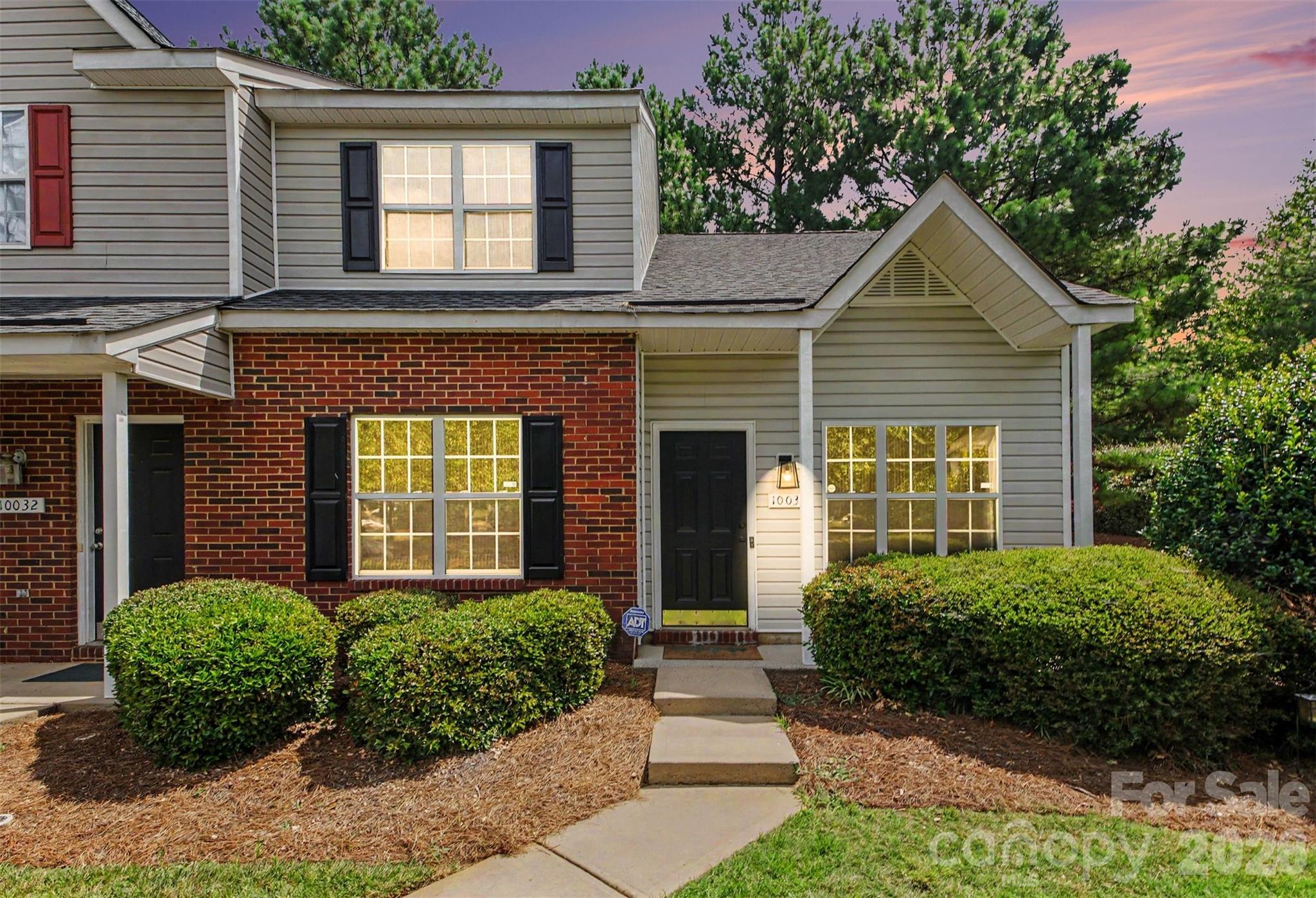 Welcome home to this beautifully maintained end-unit townhome in Charlotte's highly desirable University area! Offering a sought-after primary suite on the main level, this home combines comfort, convenience, and an abundance of natural light.

Step inside to discover a dramatic two-story great room featuring a cozy gas log fireplace, creating the perfect space for relaxing or entertaining. The spacious kitchen is designed for everyday living with ample cabinetry, generous counter space, and recessed lighting, making meal preparation a breeze. The adjoining dining area opens to an oversized private patio, providing an ideal setting for outdoor dining, morning coffee, or gathering with family and friends.

The main-level primary suite offers a peaceful retreat with a spacious bathroom featuring a double vanity. Upstairs, you'll find two additional bedrooms and a full bath, also equipped with a double vanity for added convenience. One of the upstairs bedrooms includes a walk-in closet, providing excellent storage space.

Additional highlights include a utility storage room located off the rear patio and the added value of the refrigerator, washer and dryer conveying with the home.

Ideally located just minutes from UNC Charlotte, I-485, shopping, dining, and everyday conveniences, this move-in-ready townhome offers the perfect blend of location, functionality, and low-maintenance living. Don't miss your opportunity to make this exceptional home yours!