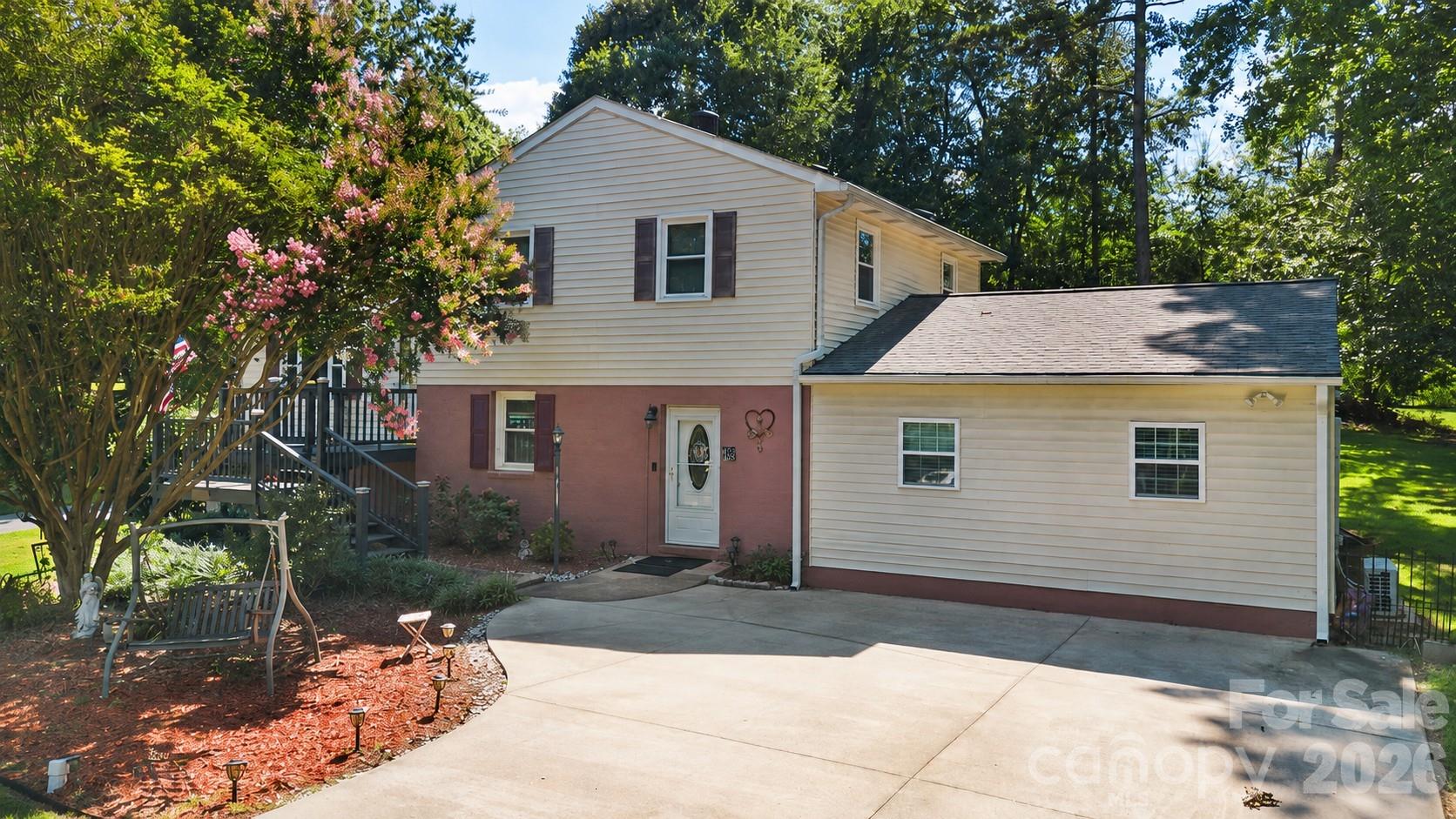 Nestled on a level .48-acre corner lot at the end of a quiet cul-de-sac in established Wyndmere, this inviting tri-level home offers the perfect combination of space, flexibility, and an exceptional Mint Hill location. The street ends at Kuck Road Park, providing a peaceful setting with open green space just steps from your front door. Conveniently located less than 11 miles from Uptown Charlotte and only 3 miles to I-485 at Novant Health Mint Hill, you'll also enjoy quick access to Mint Hill Town Center, the new Publix Shopping Center, restaurants, shopping, medical offices, and everyday conveniences.

Designed with a versatile multi-level floor plan, the home offers two convenient entrances—welcome guests through the front deck into the main level featuring the kitchen and dining area, or enjoy step-free access through the lower-level entrance directly into the spacious living room. The thoughtful layout creates distinct living spaces while maintaining an open, connected flow throughout the home.

The main level serves as the heart of the home with a spacious kitchen featuring white cabinetry, tile backsplash, breakfast bar, updated laminate flooring, electric range, microwave, dishwasher, and abundant cabinet and counter space. The adjoining dining area comfortably accommodates family gatherings while overlooking the backyard through sliding doors leading to the outdoor living spaces.

The lower level offers a warm and inviting living room centered around a gas log fireplace, creating the perfect space for relaxing or entertaining. Privately tucked away on this level is the spacious primary suite featuring a beautifully updated ensuite bath with a dual-sink vanity, oversized tiled walk-in roll-in shower, and generous closet space. A second bath within the laundry room, and unfinished utility/storage room complete the lower level, providing excellent functionality and additional storage.

Upstairs, you'll find three additional bedrooms and a full bathroom, offering flexibility for family, guests, home offices, hobby rooms, or workout space. The split arrangement provides added privacy between the primary suite and secondary bedrooms while accommodating a variety of lifestyles.

Outdoor living is equally impressive with a welcoming front porch, a screened rear porch, and an adjoining deck overlooking the spacious, fenced backyard—ideal for morning coffee, outdoor dining, pets, gardening, or weekend entertaining. A detached storage building provides additional space for lawn equipment, tools, and seasonal storage. Mature trees offer shade and privacy while the expansive yard leaves plenty of room for recreation.

Whether you're looking for space to spread out, room to work from home, or simply a convenient Mint Hill location close to everything while enjoying the tranquility of a cul-de-sac setting, 7132 Clear Crossing Lane is ready to welcome you home.