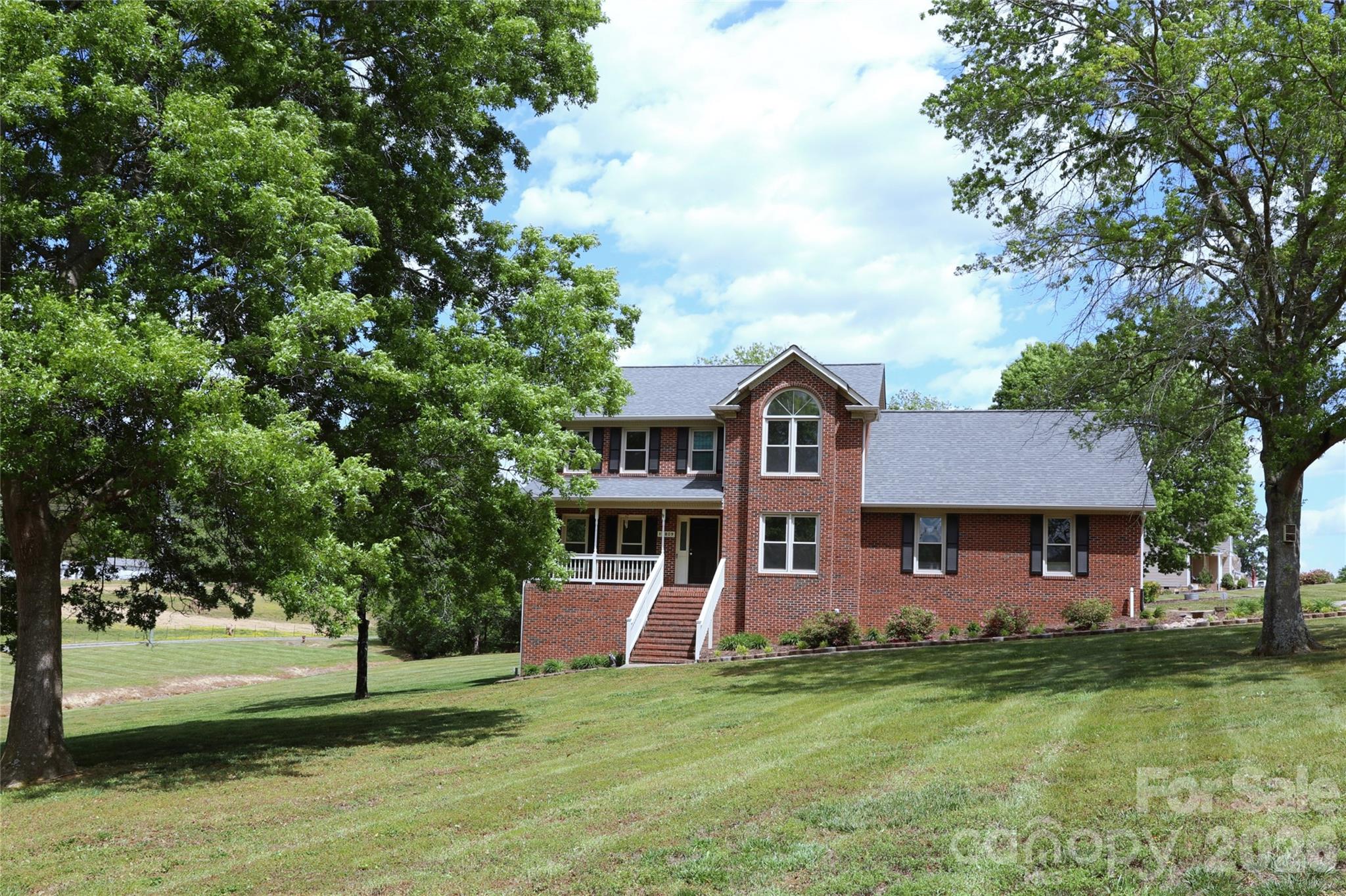 Rare opportunity with this hard to find full-brick, custom-built, 4 bedroom, 2.5 bath home PLUS bonus room PLUS separate private living room AND a full walk-out basement offering over 1000 sq ft with workshop area AND oversized main-level 2 car garage. No HOA on 1.39 acres being sold by original owner! Quality of build is noticeable throughout. A well thought-out design with both a spacious deck off the rear of the home to easily access the expansive rear yard AND a full walk-out unfinished basement with workshop area accessible via the side yard and from inside the home. Kitchen features solid-wood cabinetry, granite counters, new tile backsplash, and stainless appliances including refrigerator. Den with gas log fireplace and sliding glass door to deck. Bonus room off primary bedroom that offers ideal retreat, office, exercise room, crafting, hobby room, or nursery… can be personalized to your needs! Primary bedroom has walk-in closet and primary bathroom with double vanity and new LVP floor. New LVP throughout main level and new carpet upstairs. Oversized 2 car side-load garage on main level with room for additional workshop/storage for a variety of uses. This home offers an ideal design for maximizing storage and customizing space to your personal needs. Newly painted throughout and popcorn ceilings removed. New lighting throughout most of home. New Water Heater 9/2025. Replacement windows with double hung, tilt-in windows for easy maintenance and cleaning. Downstairs HVAC and basement ductwork replaced in 11/2025 and 1/2026. Upstairs HVAC replaced in 2015. Wood burning stove in basement is a work horse and has been used in the past to heat the entire home as a cost savings! Connected to city water but well at right rear of property if wanted to be utilized for irrigation. Septic field is at front left of property so endless possibilities for personalizing the property or installing a pool!