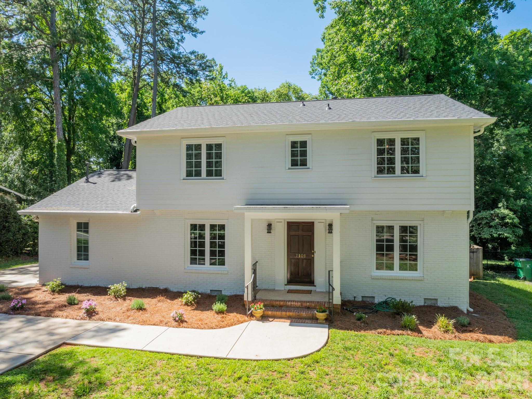 Welcome to 7101 Sherbourne Drive, where thoughtful updates and enduring quality come together in a home designed for everyday living. This refreshed 4-bedroom, 2.5-bath residence offers more than 2,300 square feet of move-in-ready space in Starmount, a well-established Charlotte neighborhood, just minutes from SouthPark and Uptown. The fully renovated kitchen serves as the heart of the home, featuring custom cabinetry, quartz countertops, and KitchenAid appliances. Newly refinished floors and fresh paint throughout create a bright, cohesive feel from the moment you enter. The layout has been thoughtfully improved with expanded openings that enhance flow while preserving distinct spaces for gathering, working, and relaxing. A sunroom with brick accent walls provides flexible space filled with natural light, while the updated mudroom and laundry area add everyday convenience. Upstairs, the spacious primary suite features a custom closet and private ensuite bath, while three additional bedrooms and a full bath offer flexibility for family or guests. Outside, the fully fenced backyard features an elevated terrace that extends the living space outdoors, opening to a spacious, level lawn. A newly renovated storage shed provides additional storage and functionality. The home's core systems have all been updated within the last two years, including a new roof, siding, HVAC, windows, and water heater.