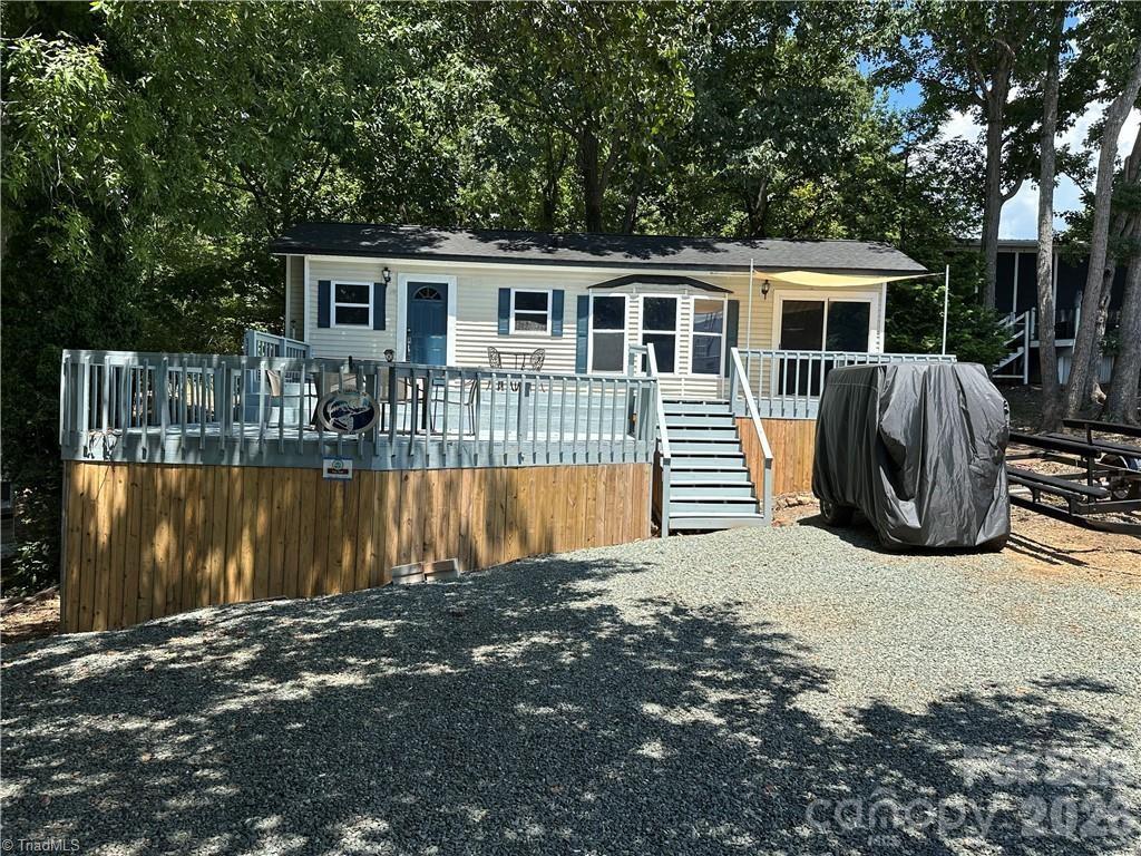 Welcome to life at the lake! This charming modular home is located inside the gated, waterfront community of Badin Shores Resort on Badin Lake. The home features 1 bedroom, 1 full bath, a cozy living area, and a kitchen that boasts solid surface countertops and stainless-steel appliances—perfect for full-time living or a weekend escape. Step outside to a spacious two-level deck designed for entertaining and relaxing with guests. Sitting on a generous lot, the property offers ample parking for your vehicles, boats, trucks, and golf carts. Eligible for conventional financing, this modular home offers a rare opportunity for both primary and secondary homeowners.
Badin Shores Resort is a golf cart-friendly community packed with resort-style amenities including a pool, beach area, playground, putt-putt course, sport courts, clubhouse, and all paved roads for easy access. Whether you're seeking a peaceful retreat or an active lake lifestyle, this is your chance to have it all!