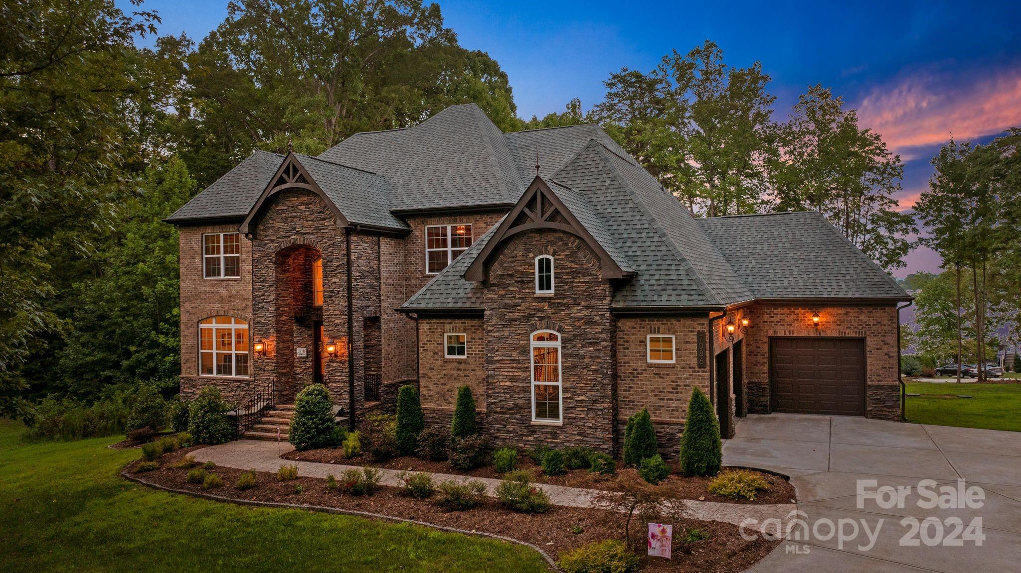 As you pass through the gates of Harbor Oaks, you’re welcomed into a secluded waterfront haven on Lake Norman, set on over 3.5 acres of pristine land. Enjoy year-round main channel views from the comfort of your home. This expansive home, designed with entertaining in mind, boasts more than 7,000 square feet of flexible space, perfect for hosting year-round indoor and outdoor gatherings. The carefully crafted design fosters a luxurious lifestyle, blending peace and elegance. Whether you choose to explore Lake Norman's 500 miles of shoreline from your private dock or unwind by the fire with exclusive amenities, this property offers endless enjoyment. Conveniently located just a short drive to nearby stores, restaurants, and shops or boat to many different waterfront restaurants or popular Lake Norman destinations. Your private resort awaits!