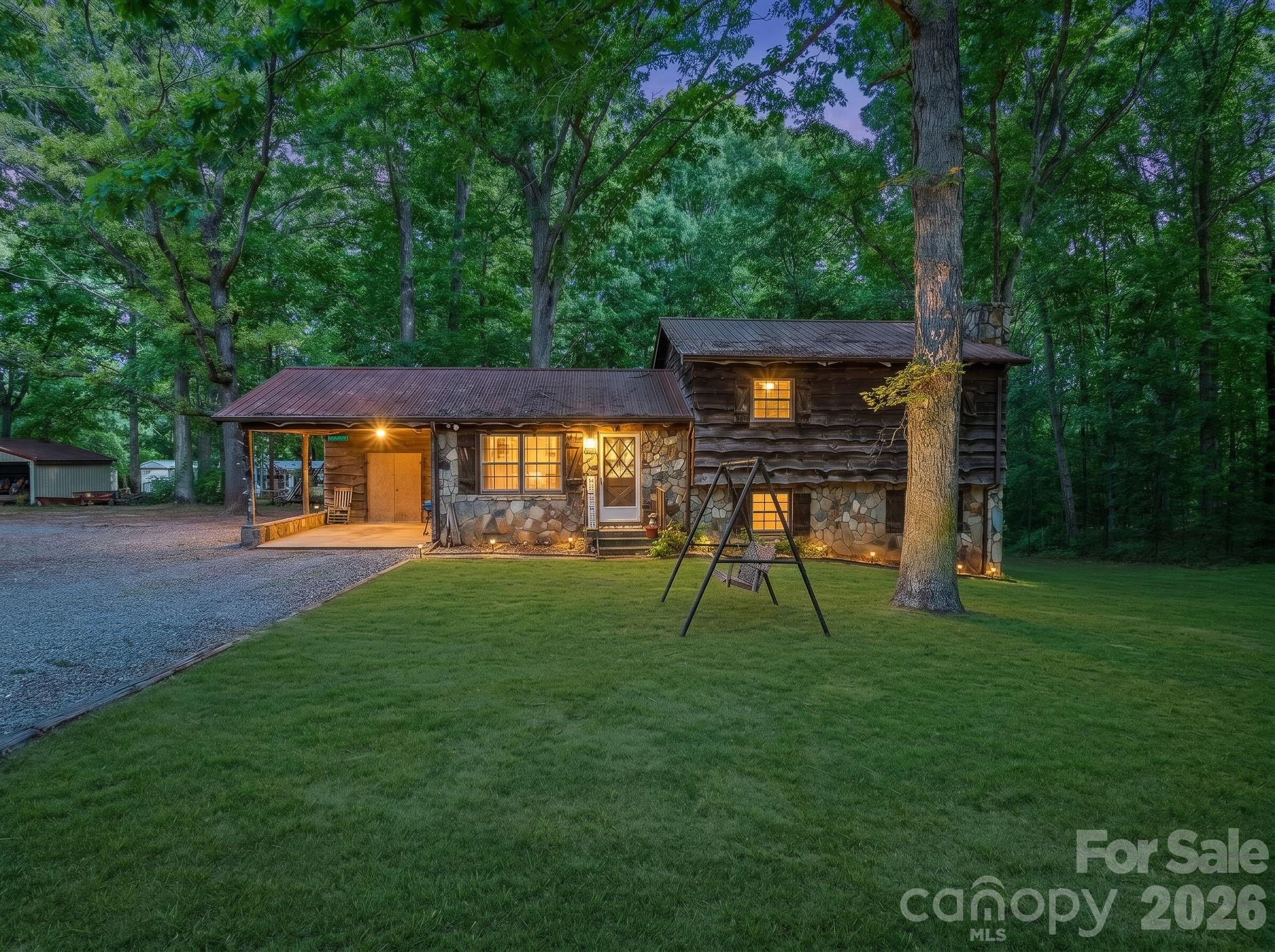 Tucked away on approximately 6 beautiful acres while still being just minutes from downtown, this one of a kind property offers something almost impossible to find… privacy, income potential, space to grow, and a home that has been genuinely loved for generations.

At first glance, buyers may see a charming cabin style home. But once you look deeper, you realize this is so much more than just a home. This property includes FOUR residences total — the primary home plus THREE additional single wide homes conveying with the property, creating an incredible opportunity for multi generational living, passive income, or long term wealth building. The additional homes have the potential to generate approximately $2,700/month in rental income alone.

The main residence was custom built and carefully maintained by the original family owners, creating a warm, timeless feel throughout. Surrounded by mature trees and peaceful views, the property offers the kind of setting that immediately makes you slow down and breathe deeper. From the welcoming long driveway to the relaxing back porch overlooking the land, every part of this property feels private, peaceful, and secure.

Inside, the three story layout offers generous space for everyday living and entertaining. The main level features the primary living areas along with a beautiful rustic kitchen that perfectly complements the home’s cozy cabin feel. The upper level features the bedrooms, while the fully finished basement showcases a stunning stone fireplace that adds warmth and character to the home’s inviting atmosphere. The home has been exceptionally maintained over the years and gives buyers the opportunity to enjoy its charm as is or personalize and modernize over time.

Beyond the homes themselves, the property continues to impress with a detached three car garage/shop, additional storage buildings, abundant parking, and still plenty of open land remaining throughout the property. Whether you dream of projects, hobbies, workshops, equipment storage, gardening, or simply enjoying the freedom of wide open space, this property gives you room to create the lifestyle you want.

Major updates include a newly installed septic system for the primary residence completed last year, adding peace of mind for future owners.

Properties like this rarely become available — especially this close to downtown while still offering the feeling of your own private retreat. A true generational property with income producing potential, character, privacy, and endless possibilities all in one.