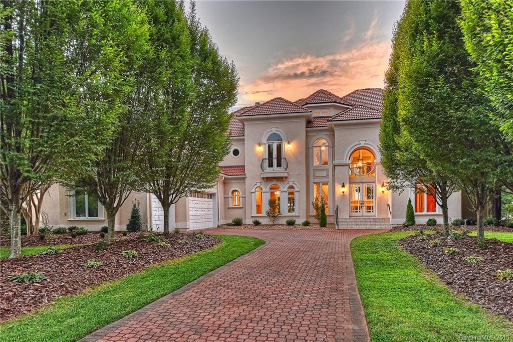 Enjoy expansive sunset views of Lake Norman from this completely updated villa on one of The Peninsula's most desirable streets. Award winning G.M. Helms-constructed custom home features a stylish new gourmet kitchen with chef grade appliances, completely updated master bath, resurfaced hardwoods, tasteful fixtures, rich craftsmanship, as well as a dramatic spiral staircase. Elevator serves all 4 levels of this open layout which highlights unrivaled views from almost every room.