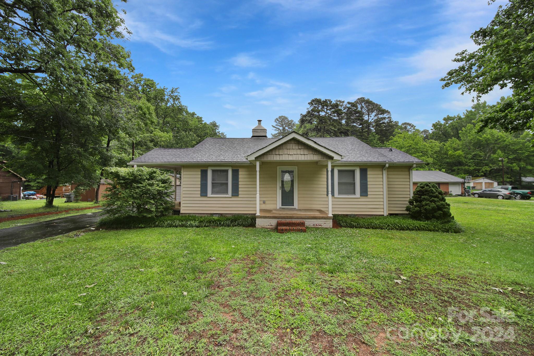 Welcome to a suburban feel, located just minutes from uptown! This charming home sits just 10 minutes outside of center city on over .8 acres. Renovated home, lovingly owned and maintained. Butcher block countertops, refinished real hardwood floors, and a beautiful fireplace mantel with gas logs. Tiled floor in master bathroom and a tile surround shower. Large 1 car garage offer additional storage & carport. Two covered porches and a newer deck. Large level lot - fence installed by current owner to offer privacy and safety for pets. Mud sink in the laundry room. Convenient to the Airport, Uptown & Southend!