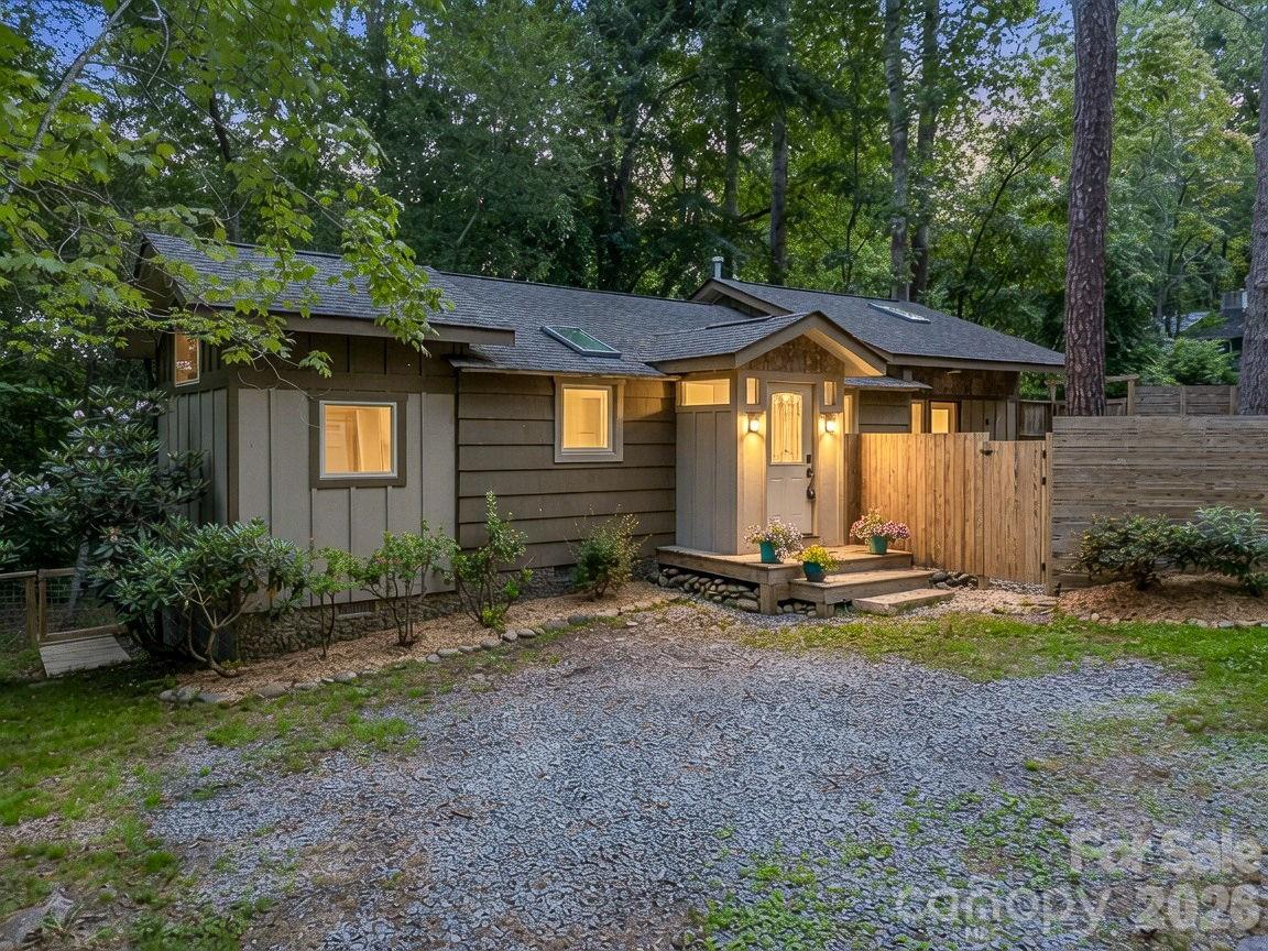 Nestled in a private setting just a short walk from Lake Tomahawk, the Black Mountain Golf Course, pool, walking trails, and downtown Black Mountain, this charming 3BR/1BA home offers the perfect combination of convenience and tranquility. Originally built in 1900 and completely remodeled with an addition in 2014, the home features a bright, contemporary design with abundant natural light throughout. The well-appointed gourmet kitchen is ideal for everyday living and entertaining, with large windows overlooking rhododendrons, native landscaping, and the peaceful backyard. Multiple living areas provide flexibility for relaxing, gathering with friends, or creating a home office or media room. Skylights enhance the inviting interior, while the jetted tub offers a perfect place to unwind. Outdoor living is a highlight, with spacious decks overlooking a wooded setting, a small babbling stream, and native mountain flora. Fully fenced front and back yards provide privacy and secure space for children and pets to play. Move-in ready and equally suited as a primary residence or mountain retreat, this property offers a rare opportunity to enjoy the best of Black Mountain living in a serene, walkable location.