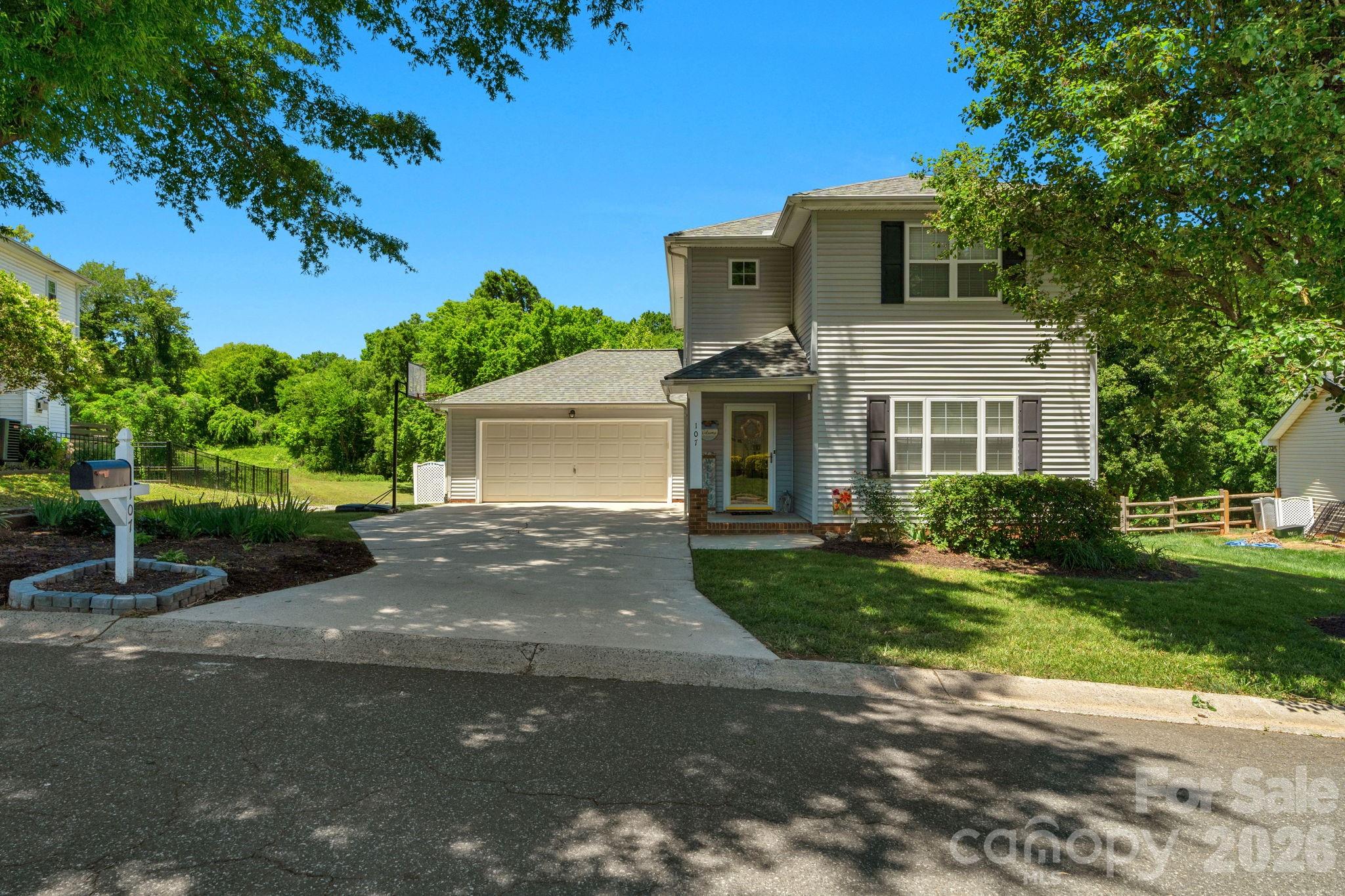 Live within walking distance of historic downtown Belmont, NC, in this 3-bedroom, 2.5-bathroom home located in the highly desirable Adams Bluff Subdivision. Ideal for outdoor enthusiasts, the property offers quick access to the Abbey Creek Greenway, located directly behind the home, which takes you straight to the Belmont Recreation Center and Kevin Loftin Park on the Catawba River. Inside, the main level offers a seamless open floor plan between the dining and living rooms, complete with a cozy gas-log fireplace and laminate wood flooring throughout. The large kitchen boasts extensive counter and cabinet storage, a classic tile backsplash, and stainless steel appliances, while a stylish sliding barn door leads to the main-floor laundry room and attached 2-car garage. Upstairs, the primary bedroom features an elegant tray ceiling and a walk-in closet, and the recently updated primary bath includes modern tile floors, a walk-in shower, and a new vanity cabinet with split sinks. Bedrooms 2 and 3 share a second updated bathroom with new tile, a fresh tub and tub surround, and a single-sink vanity. Notable capital improvements include a new HVAC system installed in 2021. The property faces open green space with access to the future greenway expansion, and features a large back deck with a gazebo that steps down to a brick paver patio and a fully fenced backyard. Belmont offers the small-town feel just 25 minutes west of Uptown Charlotte. Downtown offers restaurants, pubs, breweries, retail, parks, and family-friendly events all within walking distance.  Don't let this one slip through your fingers!