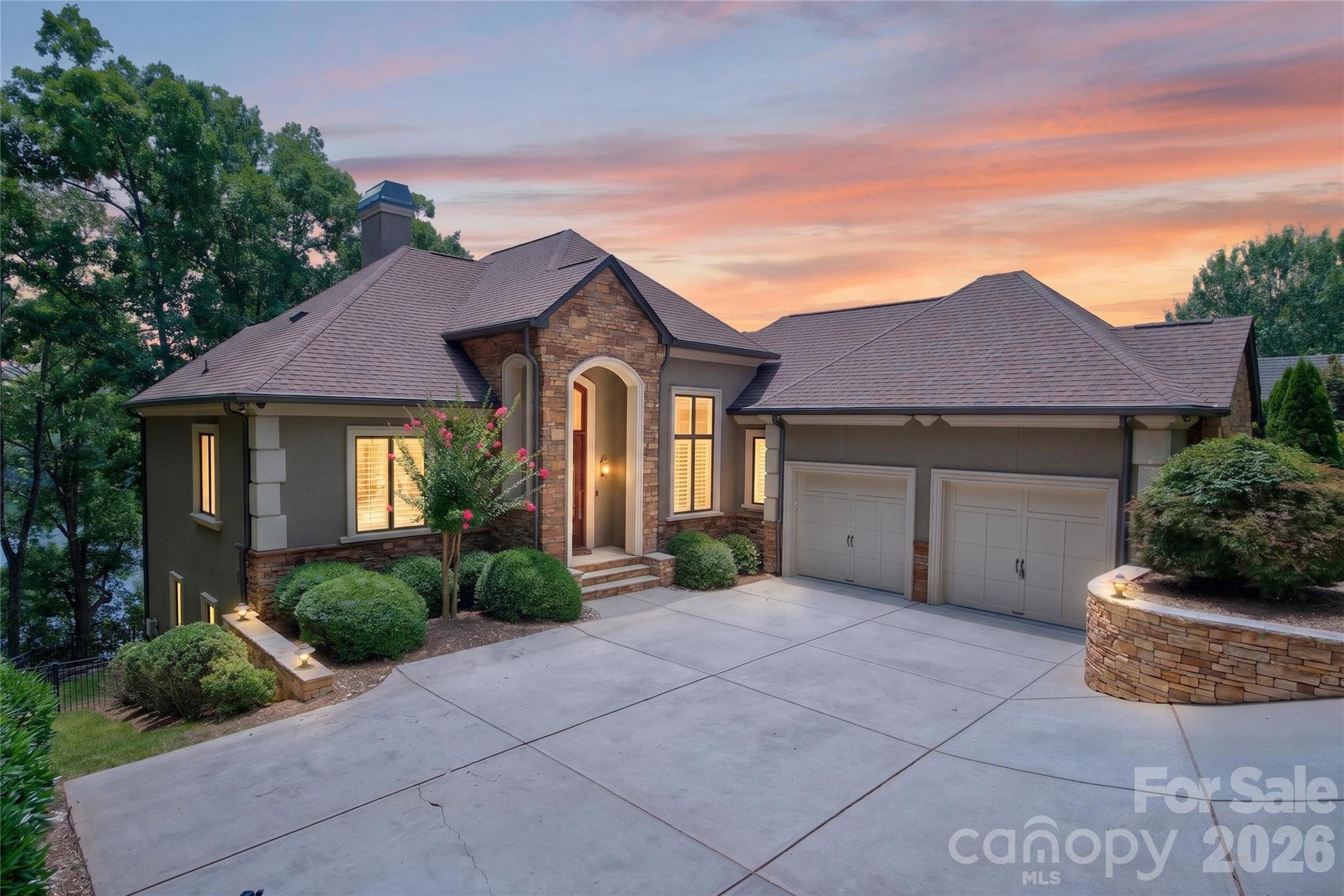 LAKEFRONT LUXURY | BIG WATER VIEWS | PRIVATE COVERED DOCK | ELEVATOR

Freshly updated with newly painted warm white interior and ready to make a stunning first impression, this exceptional custom Yeary Homes lakefront retreat offers the Lake Wylie lifestyle buyers dream about but rarely find.

Imagine starting your morning with coffee overlooking sparkling main-channel views, spending the afternoon boating, paddleboarding, or swimming from your private covered dock, then gathering around the lakeside fire pit as the sun sets across the water. This is not simply a beautiful home. It is a place where every day feels like a vacation.

Perfectly positioned in the prestigious gated community of Reflection Pointe, this home combines deep water, breathtaking long-range views, elevator access, and a private covered dock to create one of the area’s most complete waterfront lifestyles.

Designed to celebrate the lake, walls of windows frame panoramic water views from nearly every rear-facing room. Fourteen-foot coffered ceilings, custom built-ins, rich architectural details, and an open floor plan create an inviting atmosphere that feels both elegant and comfortable. Whether entertaining a crowd or enjoying a quiet evening at home, the layout was designed to bring people together.

The chef’s kitchen is the heart of the home, featuring granite countertops, extensive pull-out cabinetry, a premium Dacor gas cooktop, new appliances in 2024, generous prep space, and seamless flow into the dining and great room, all overlooking the water.

Retreat to the luxurious main-level primary suite where peaceful lake views greet you each morning. A spa-inspired bath and spacious layout create the perfect private escape, while the elevator provides effortless access to every level, making the home ideal for today’s lifestyle and tomorrow’s convenience.

The walkout lower level offers incredible flexibility with a spacious family room featuring a second fireplace, wet bar, three additional bedrooms, flex space, abundant storage, and a screened porch that invites guests to relax long after the day on the water has ended.

Outdoor living is equally impressive. Expansive covered porches, a screened retreat, flagstone terrace, beautifully terraced landscaping, fenced backyard, Zoysia lawn, lake-fed irrigation, and a lakeside fire pit create unforgettable spaces for entertaining or simply enjoying the peaceful surroundings.

The private waterfront amenities make lake living effortless. The covered dock features a motorized boat lift, separate floating PWC dock, internet service, city water, dedicated music zone, and HD security camera system. The deep-water location provides dependable boating access throughout the year, allowing you to enjoy Lake Wylie to its fullest.

Additional luxury features include whole-house automation, surround sound, plantation shutters, aluminum-clad windows, dual HVAC systems, tankless water heater, whole-house surge protection, epoxy-coated garage and storage floors, plus an oversized garage with extra space for a workshop, golf cart, or recreational equipment.

The sloped driveway allows the home to sit closer to the shoreline, creating a more immersive waterfront experience with enhanced privacy and spectacular panoramic views that are difficult to replicate.

Just minutes from Belmont, Charlotte Douglas International Airport, restaurants, shopping, and everything Lake Wylie has to offer, this freshly refreshed waterfront retreat delivers the luxury, convenience, and lake lifestyle discerning buyers have been waiting for.

Live the lake life. Every single day.