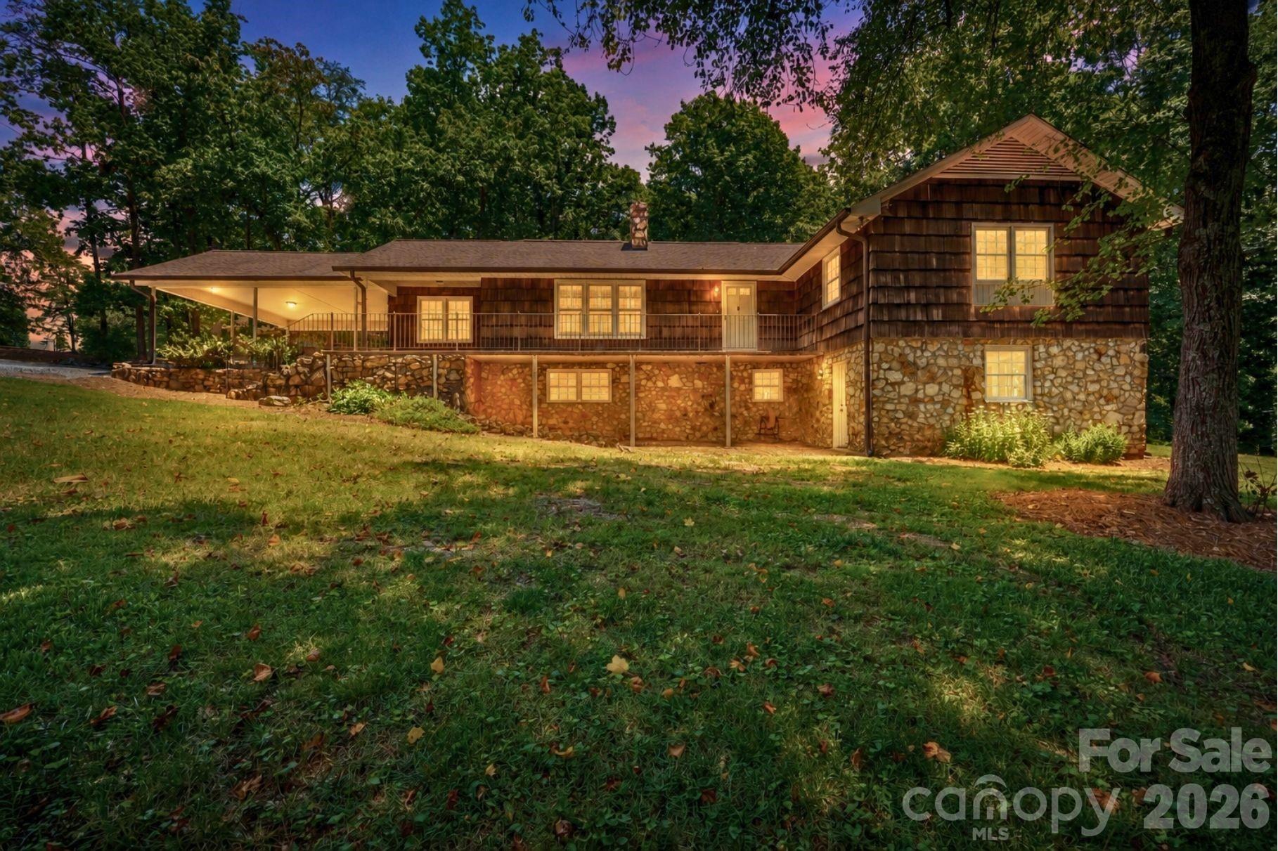 Nestled on 3.12 private acres, this one-owner home is full of character and charm, offering the perfect combination of timeless appeal, modern updates, and flexible living space. Lovingly maintained by the same family since it was built, this unique property is ready for its next chapter.

The main level features a beautifully updated kitchen with granite countertops, an oversized island, abundant cabinetry, and generous prep space—perfect for entertaining or everyday living. The inviting living room showcases a stunning stone fireplace, while luxury vinyl plank flooring and neutral paint throughout create a warm, welcoming atmosphere. The main level also offers 3 spacious bedrooms and 2.5 bathrooms, including a comfortable primary suite.

The fully finished basement provides exceptional versatility with a second kitchen, 2 additional bedrooms, and 1 full bathroom, making it ideal for a mother-in-law suite, multi-generational living, guest quarters, or potential rental opportunity.

Outside, you'll enjoy the privacy and beauty of 3.12 acres with plenty of room to garden, play, or simply relax. An attached two-car carport provides everyday convenience, while the detached garage/workshop offers endless possibilities for hobbies, storage, equipment, or a home business.

If you're searching for a home with acreage, a finished basement with a second kitchen, workshop space, and a property filled with warmth, character, and charm, this one-owner home is a rare find. Schedule your private showing today!