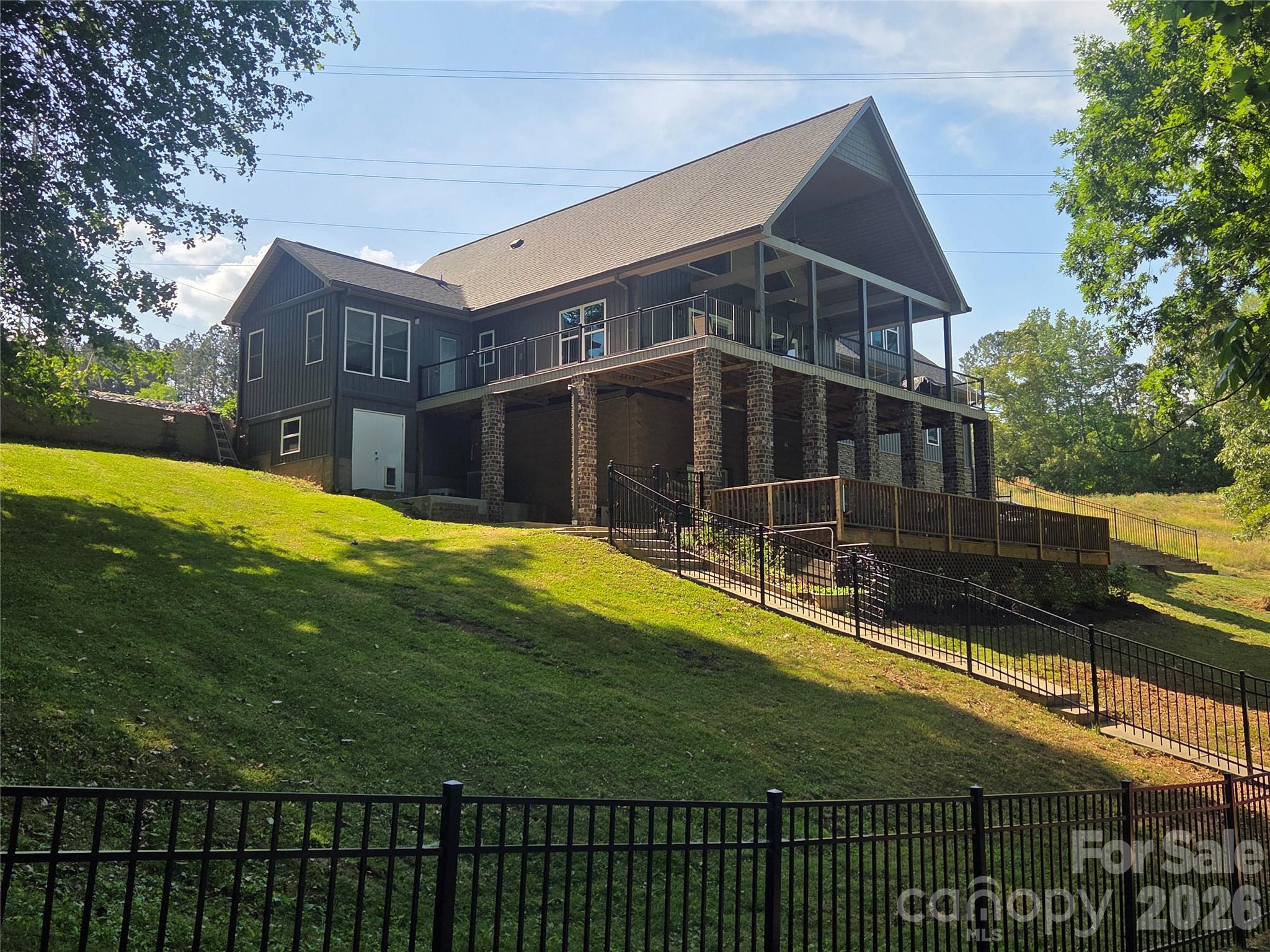 This beautiful Lake Norman waterfront oasis combines spacious multi-level outdoor layout built for Lake Life!

Situated on an expansive private 1.67 acre wooded lot, this 3900+ square foot home offers an unmatched blend of privacy and open water access.  There is a floating dock with covered boat slip and 3 jet ski floating docks.  Even at record low water levels there is ample water to get out and enjoy the lake.

The main level welcomes you with endless water views, leading seamlessly to a sprawling covered deck designed for outdoor dining and entertaining.  Enjoy beautiful sunrises and water views from the master bedroom which also has a large closet with its own washer and dryer. 

The upper level has a bedroom, full bath and an office area with great view of the lake as well, and the massive bonus room above the garage would make an excellent game room for family enjoyment.

The lower level / walk out basement, has a living room and kitchenette complete with refrigerator.  There is a full bath and laundry room and 2 flex rooms as well. As you step outside you'll find a hot tub and hammock for endless waterfront relaxation.  In addition there is another deck great for your next game of corn hole.

Let's not forget the basement under the 3 car garage.  It has a high ceiling and makes a wonderful workshop with the extra large garage door to get the projects in and out.  And if you love your pet, you will love the pet condo/storage on the lower level, with doggy door access and its own window.  Morrison farm park is right across the street, and Lake Norman State Park is nearby.  No restriction on vacation rental.

This home is being sold turn key with all furnishings, as well as a 24' Sweetwater pontoon with 115 HP outboard, 1 Bombardier Jet ski, and a Gravely zero turn mower.

History - Home built in 2002 but completely renovated and expanded in 2022.  Added 3 car garage and bonus room over, and high ceiling workshop under garage. A mudroom and foyer was added as well as an expansion to the master bedroom, and a roof over the lakeside deck, as well as replacement of all exterior decks and porches. All windows and exterior doors were replaced and a new roof, as well as low maintenance exterior finishes - stone, siding, etc.

Benefits of this location - East facing on waterside so you have beautiful sunrises, and in the afternoon shade instead of blazing hot sun.  In the cove you have peace and quiet it's great for swimming and no boats or jetskis buzzing by creating wakes that cause wear and tear on piers and boats.  Nice deep water.