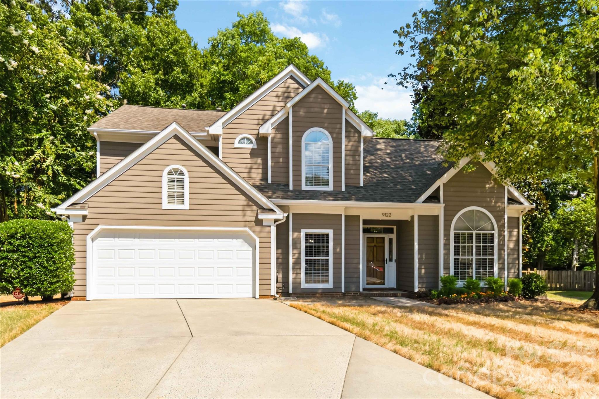 Welcome to this beautifully updated home nestled on a cul-de-sac with a large fenced-in backyard in a community served by top-rated schools. Exterior and interior painted in 2025. Enjoy stylish updates throughout with no carpet, no popcorn ceilings, and tall ceilings throughout the home. The updated kitchen features granite countertops, new appliances, a beverage fridge, breakfast area, abundant prep space, and bar seating. The spacious living room offers a brick fireplace. A separate dining room provides additional entertaining space. Upstairs, you'll find 3 bedrooms, including a spacious primary suite with a large bath, soaking tub, and separate tile shower. All closets feature custom shelving systems. Relax on the screened-in porch overlooking the private backyard, or entertain on the oversized deck, freshly stained in 2025. Attached 2-car garage. Community amenities include a pool, basketball court, tennis, and pickleball courts. Conveniently located near shopping and dining.
