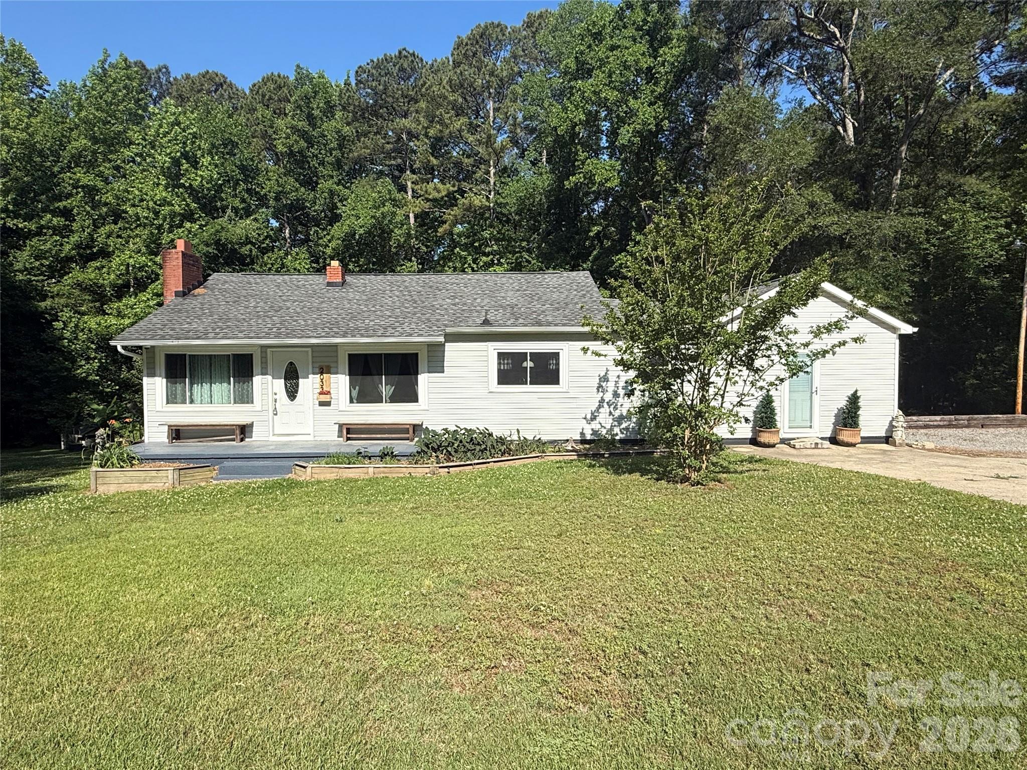 This inviting 2-bedroom, 1-bathroom home offers comfort, versatility, and room to breathe. Inside, you’ll find additional living space perfect for a family room, home office, or play area—tailor it to fit your lifestyle!  Step outside to enjoy the large covered back porch, ideal for relaxing evenings, morning coffee, or entertaining friends and family year-round. The wired outbuilding provides endless possibilities for a workshop, hobby space, or extra storage.  Situated on approximately 1 acre, this property delivers the privacy you’ve been looking for while still being convenient to everyday amenities. Don’t miss your chance to make this peaceful property your own!