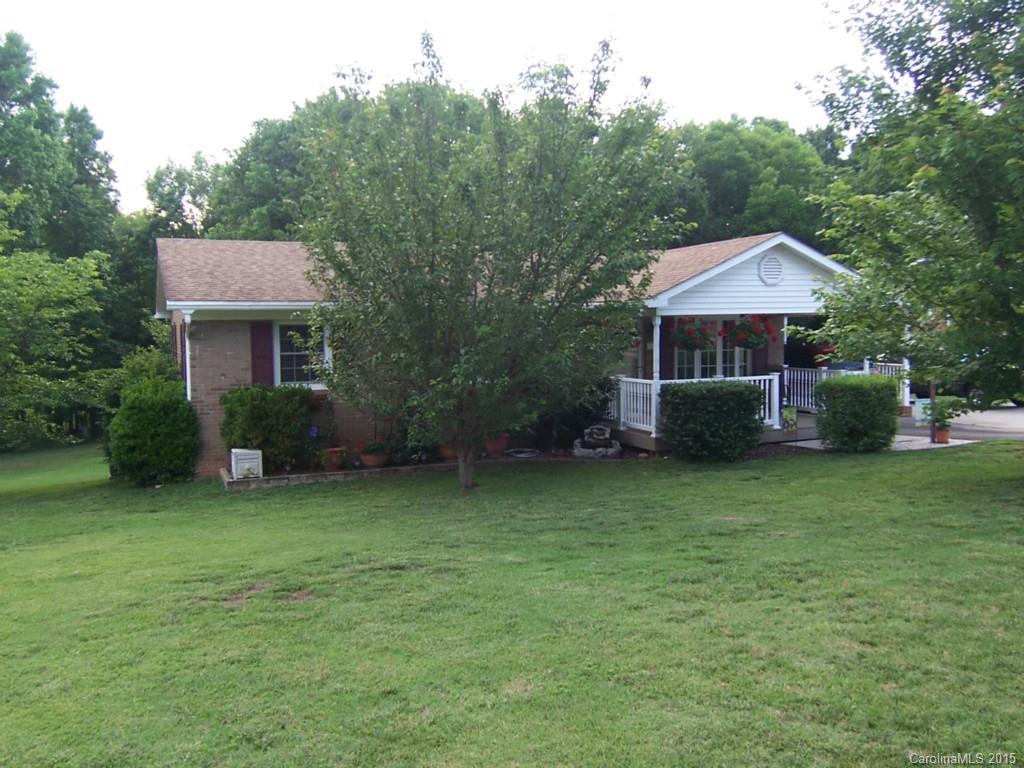 Updates galore, open floor plan, covered porch, newer roof, windows, flooring, kitchen, HVAC, deck, 2 storage buildings, 2 fireplaces with gas logs, could be 3 bedrooms, neutral colors.