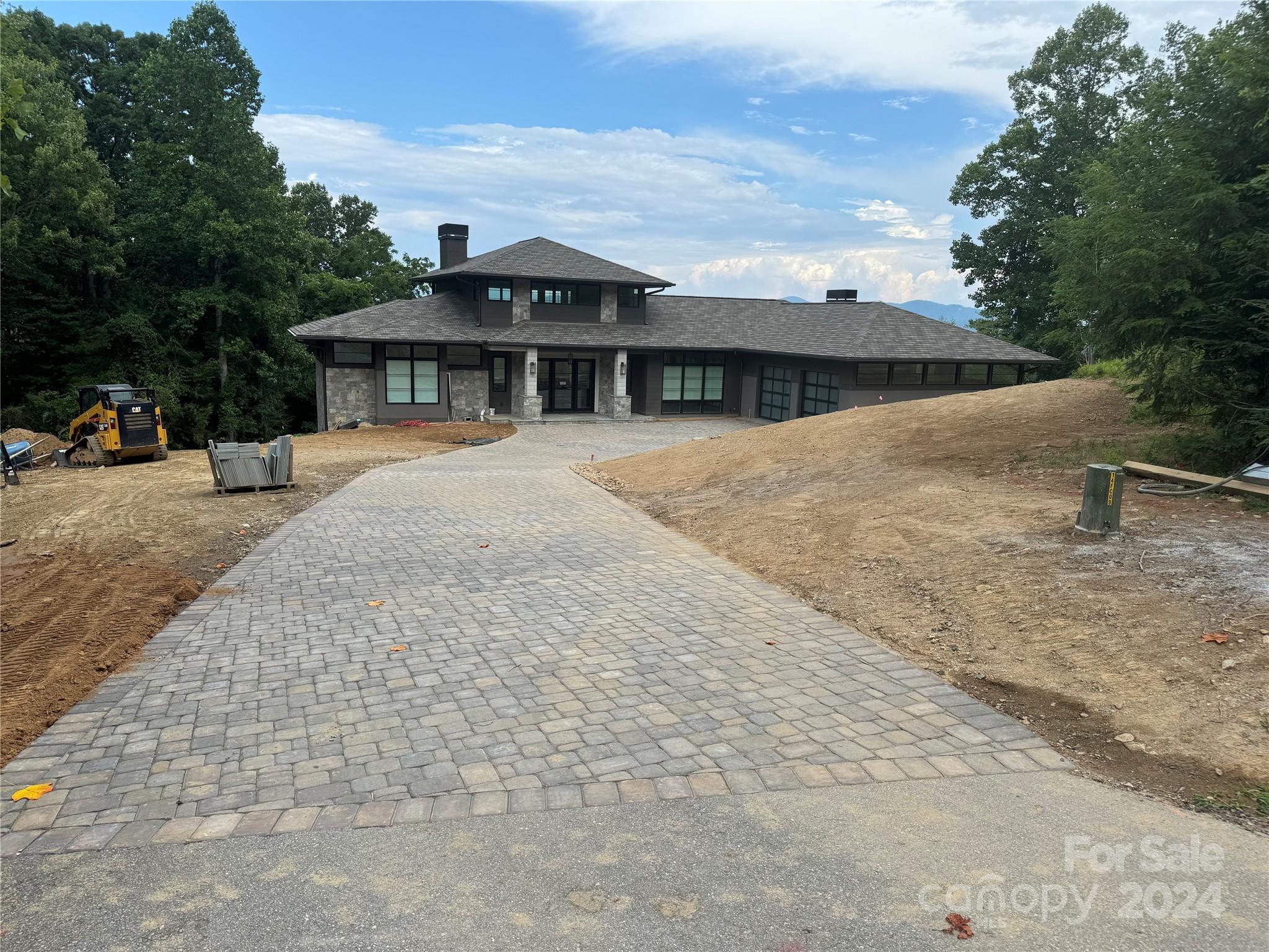 Under construction - This grand modern home in The Cliffs at Walnut Cove checks all of the boxes! Situated on a large lot near the summit of Chestnut Ridge affording privacy with HUGE long range views. The Northeasterly exposure ensures that your home will be awash with cool sunrise light. Then, in the afternoon your view remains lit up so you can enjoy it without looking directly into the sun. The moderate slope will deliver a lower level that comes out on grade. And the mature hardwoods provide a dramatic back drop for the home. This home features floor to ceiling windows in the great room and dining room, along with flat ceilings over 18 feet in the great room! Gracious outdoor living spaces round out this offering. Must see!