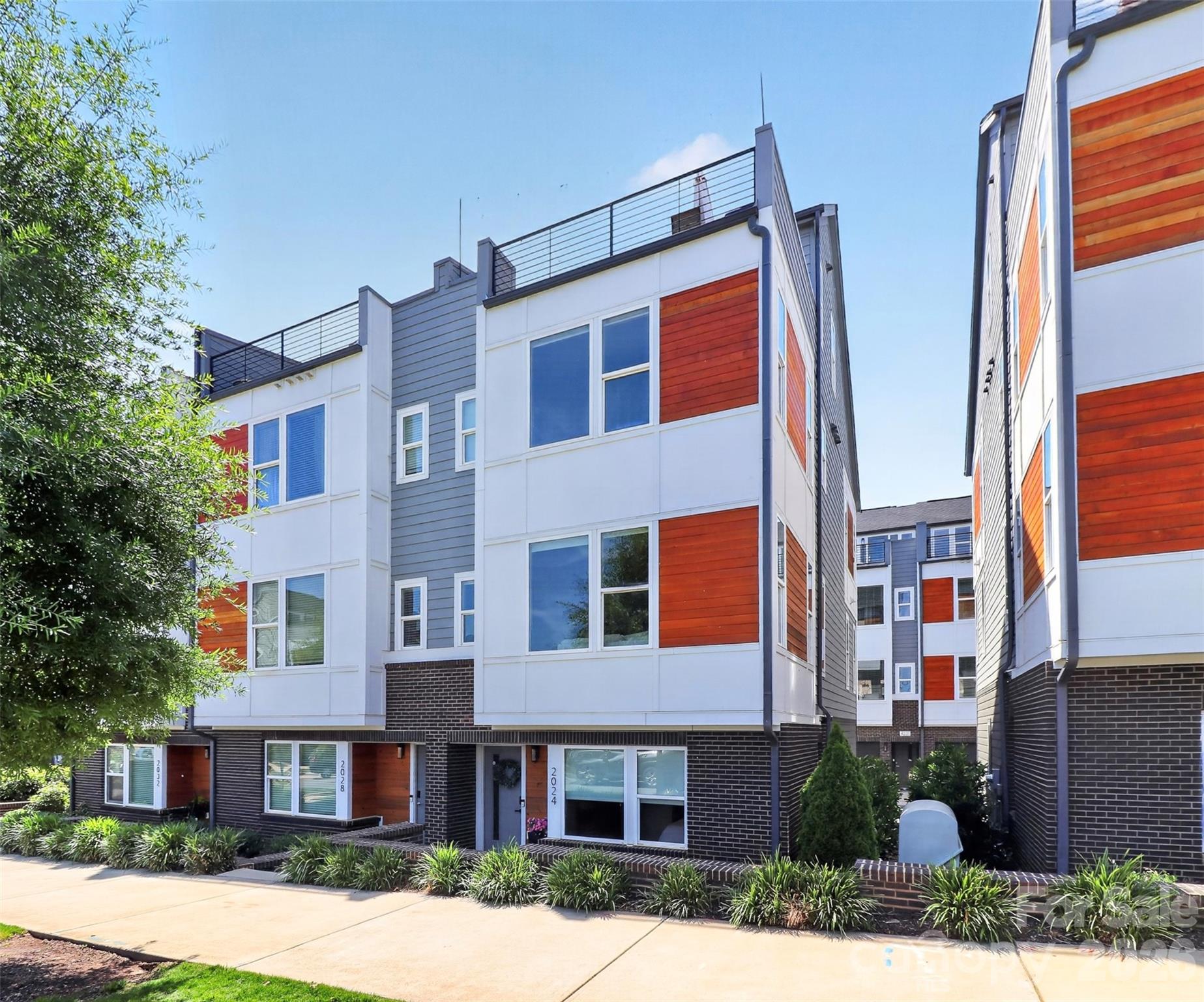 Rare opportunity with wide open city skyline views in Bryant Park Terraces. This townhome has 4 levels of modern design and contemporary conveniences. The lower level entry has a spacious foyer, guest room/office and full bath. Two car side by side garage. Main level includes upgraded kitchen with SS appliances, quartz countertops and lots of natural light. Pantry, half bath and balcony off of dining area. Upstairs, two ensuites with the primary boasting beautiful city views. Large primary bathroom with frameless glass shower. Continue up to the fourth floor bedroom/flex space with its own half bath. Roof top terrace with gorgeous skyline views of uptown and the BoA stadium. This pocket community is next door to Legion Brewing and Salt & Vinegar building, walking distance to Pinky's, Town Brewing and Rhino Market & Deli and a straight shot into the city. Airbnb friendly.