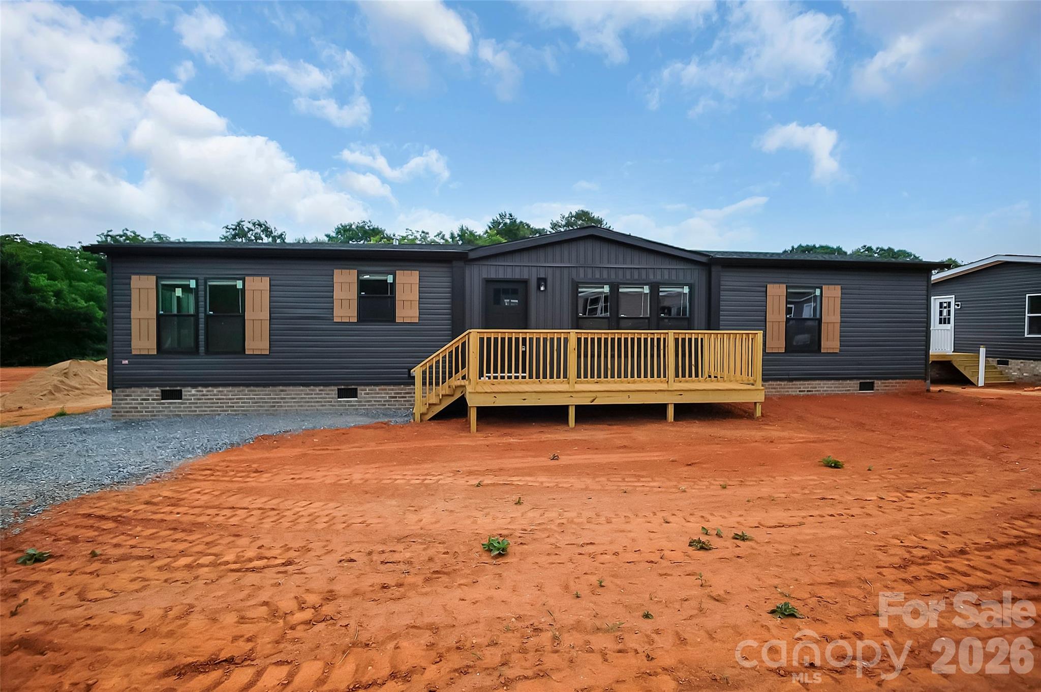 Be the first to enjoy this newly set 2026 Clayton manufactured home, offering modern design, quality craftsmanship, and comfortable one-level living. This move-in-ready home features 3 bedrooms, 2 full bathrooms, and a thoughtfully designed open floor plan that blends style and functionality.

The spacious living room is highlighted by a cozy fireplace and flows seamlessly into the impressive kitchen, making it ideal for entertaining and everyday living. The kitchen is a true centerpiece, featuring an abundance of cabinetry, expansive countertop space, and an extra-large center island that provides ample room for meal preparation, dining, and gathering.

The private primary suite offers a relaxing retreat with a spacious bedroom, walk-in closet, and an en-suite bathroom complete with a dual vanity, separate shower, and soaking tub. Two additional bedrooms and a full bathroom provide flexibility for family, guests, or a home office.

A convenient drop zone just inside the side entrance, adjacent to the laundry room, helps keep everyday essentials organized. Combining modern finishes, an exceptional layout, and brand-new construction, this 2026 Clayton home is an outstanding opportunity for buyers seeking stylish, low-maintenance living.