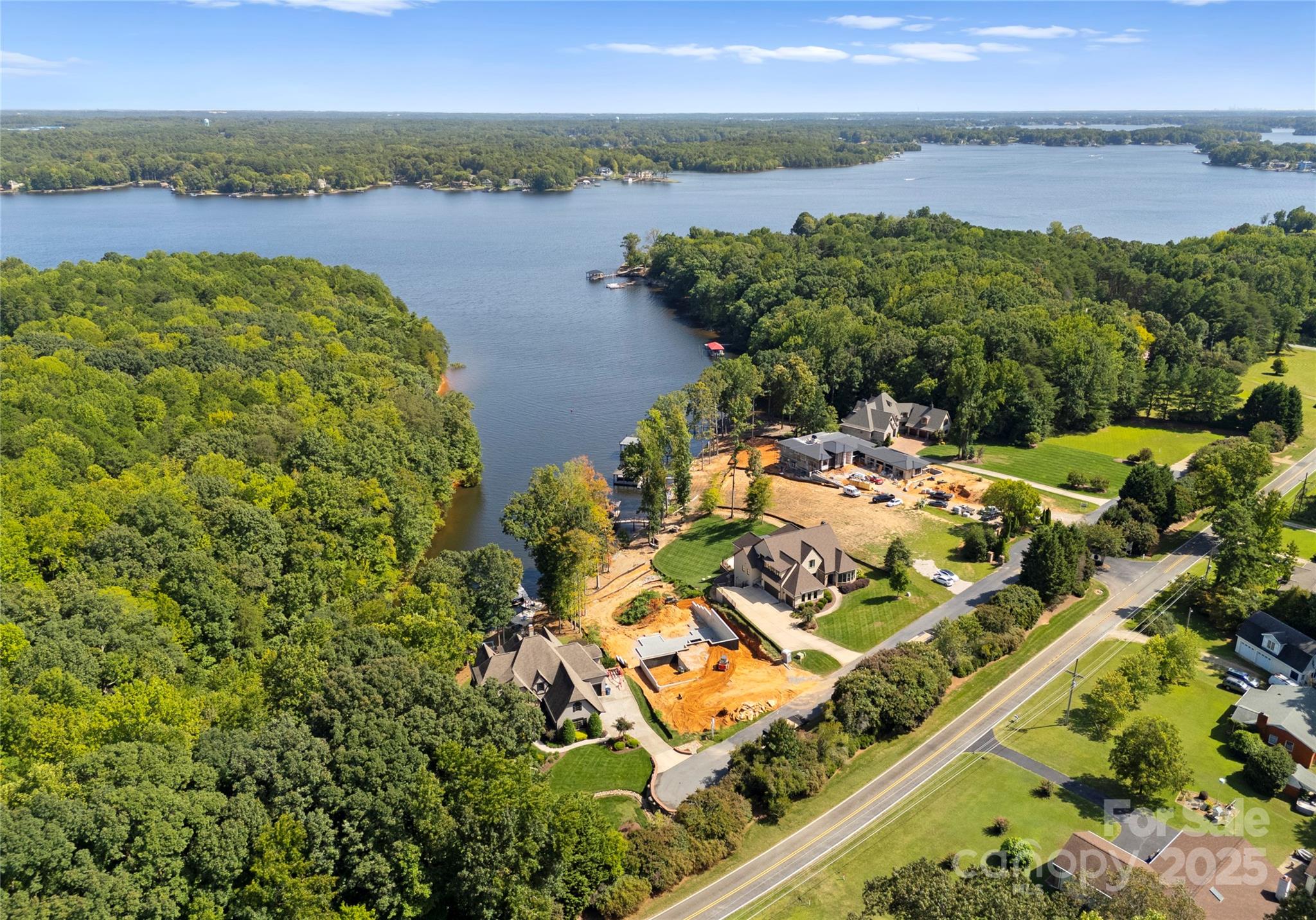 With over 100 feet of pristine shoreline & unobstructed water views, this reimagined modern waterfront estate epitomizes luxury & sophistication. Located in an exclusive, gated enclave with only seven homesites, this exceptional residence is surrounded by exquisite custom homes by Kenneth Bealer Homes.
Thoughtfully designed, featuring floating stairs & an elevator, this lakeside retreat blends cutting-edge smart home technology & timeless designer finishes for effortless elegance. With 4 beds, 5.5 bath , & an inspired floor plan, it flows seamlessly, culminating in an outdoor oasis with a resort-style pool. Set within a quiet cove yet offering long-range vistas, this home balances seclusion & natural beauty. Just 45 minutes from Charlotte, it’s close to shopping, dining, healthcare, & premier amenities while preserving the serene lakefront lifestyle. An extraordinary waterfront masterpiece, this home invites personalization to reflect your vision. Call the listing agent for details.