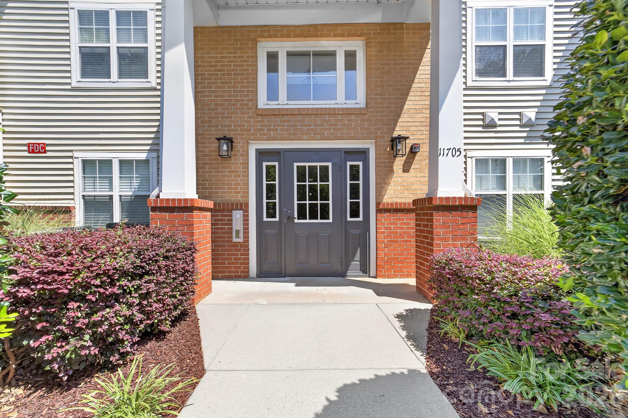 Located just minutes from the Bowl at Ballantyne, this 2 Bedroom 2 Bathroom 2nd floor condo with vaulted ceilings includes 1 car garage and a flex room that could be used as a 3rd if desired. This split-bedroom floor plan features a roomy primary suite with an oversized walk-in closet. The kitchen has ample storage space with many cabinets and an optimal layout. The open floor plan allows for the living and dining room to have large furniture.
Relax on your private, covered patio overlooking peaceful green space — with bonus storage included.  Living in Copper Ridge mean’s  you’ll enjoy proximity to shops, dining, and major highways, plus resort-style amenities— two pools, tennis courts, fitness center, and clubhouse.
