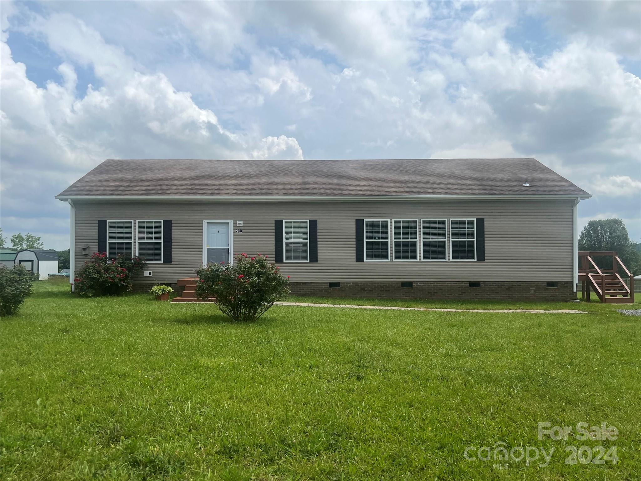 Beautiful modular home on large 1/2 acre lot.  Home has been completely refurbished.  All main rooms has 4.5" crown molding, new carpet and LVP throughout, massive kitchen, center island, & cabinets galore.  Large great room with fireplace. Spacious primary bedrooms, primary bedroom with walk-in jetted handicap tub and separate shower. Laundry room perfect for folding, ironing clothes, sink.