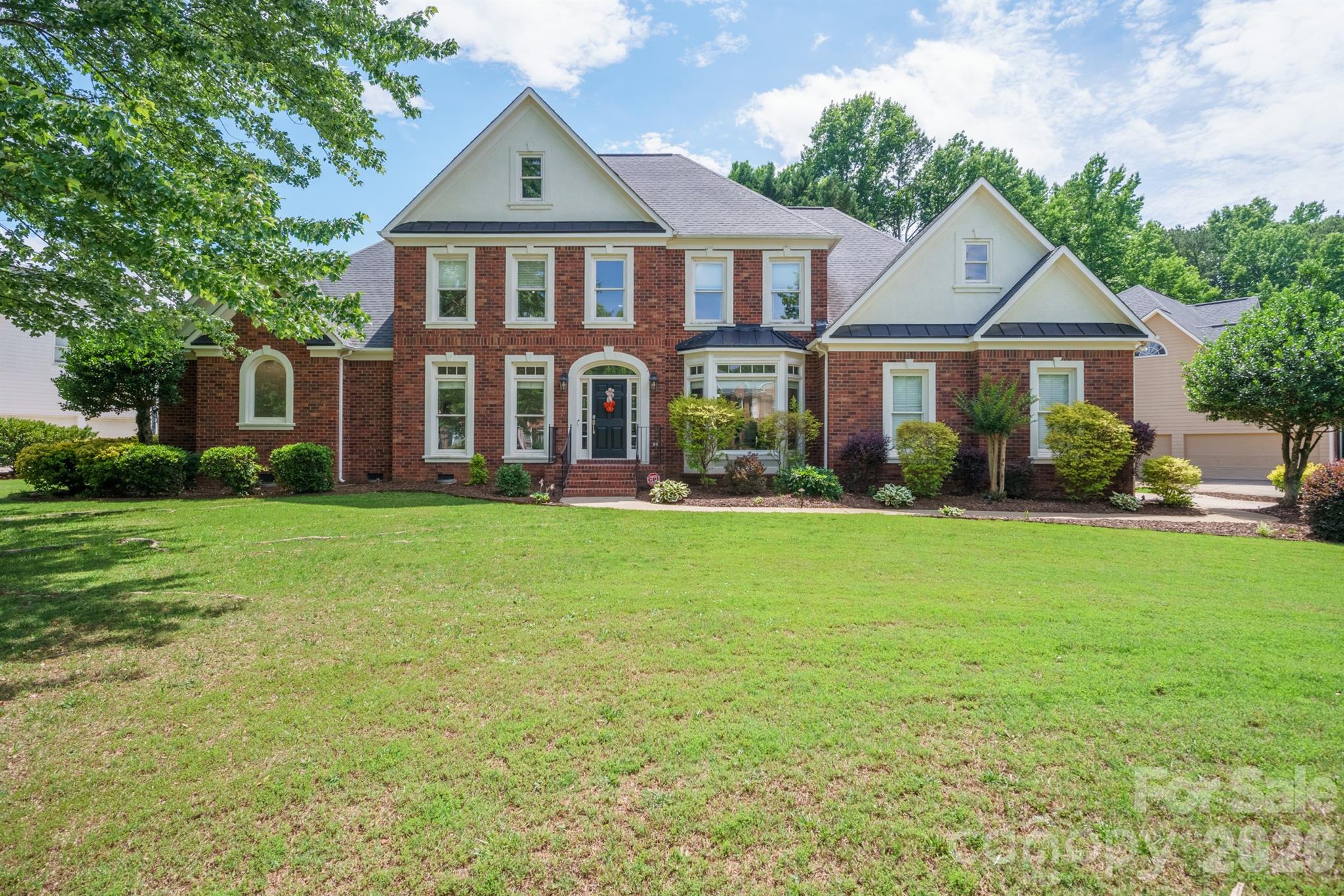 This stunning two-story home in the highly sought-after Hamptons community is ready for its next owner! Situated on nearly a half-acre corner lot just off a cul-de-sac, this property offers exceptional curb appeal with brick and fiber cement siding, a side-load three-car garage, and a charming fenced backyard complete with a screened porch and deck—perfect for entertaining or relaxing outdoors. Step inside to a dramatic two-story foyer with gleaming hardwood floors (refinished 2022) and upscale finishes throughout. The main level features a formal dining room with wainscoting, recessed ceiling, and crown molding, a private home office with French doors, and a spacious two-story living room with built-in shelving and a gas fireplace. 

The recently updated dream kitchen showcases quartz countertops and backsplash, white cabinetry, stainless steel appliances including new refrigerator in 2025, dishwasher 2026 and a gas range. Single-basin sink, pendant lighting, single-stage filter, pantry, and an adjoining spacious breakfast nook for casual dining. A recently added drop zone with shiplap wall detailing provides stylish everyday functionality. Main-floor laundry includes an electric dryer connection, and the garage refrigerator/freezer conveys with the home. 

The main-level primary suite features an elevated ceiling and a private enclosed sitting room—ideal for a reading nook, office, or quiet retreat. The recently updated spa-like primary bathroom includes dual vanities, ceramic tile flooring, a walk-in shower with niche, soaking tub with ledger stone accent wall, and separate his-and-her walk-in closets. 

Upstairs, you’ll find three additional bedrooms, including two connected by a Jack-and-Jill bath and a third with its own attached full bath. A massive bonus room offers incredible flexibility and could easily serve as a media room, playroom, home gym, or second living area. It also features a hidden room, creating the perfect secluded office, hobby room, or private retreat. 

Additional updates include a gas furnace (2022) and tankless water heater (2025). 

Enjoy resort-style amenities in one of the area’s premier communities, including two outdoor pools (one with waterslides), two clubhouses, playgrounds, tennis courts with pickleball area, volleyball court, and community events throughout the swim season. Conveniently located within walking distance to North Mecklenburg Park and just minutes from Birkdale Village, Lake Norman, uptown Charlotte, major highways, the airport, and top-rated schools.