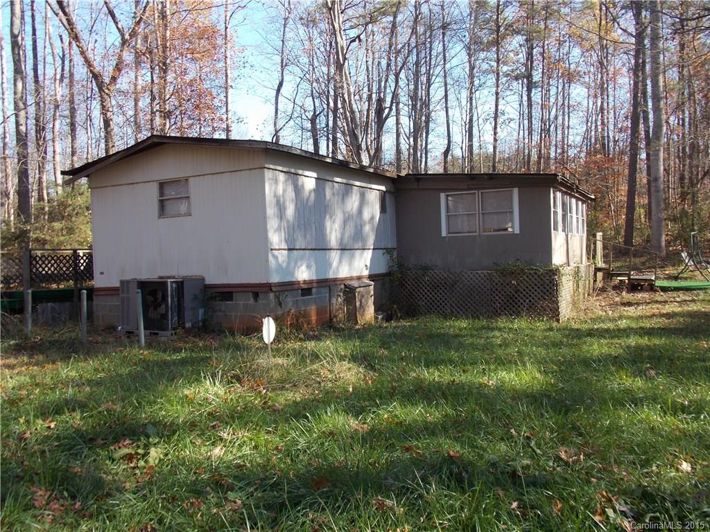 Tranquil two bedroom mobile home near Lake Wylie with existing well and septic.  The home features two bedrooms, two full bathrooms, a kitchen, living room, enclosed patio, and rear deck.  Renovate this home to your liking or build your own home.