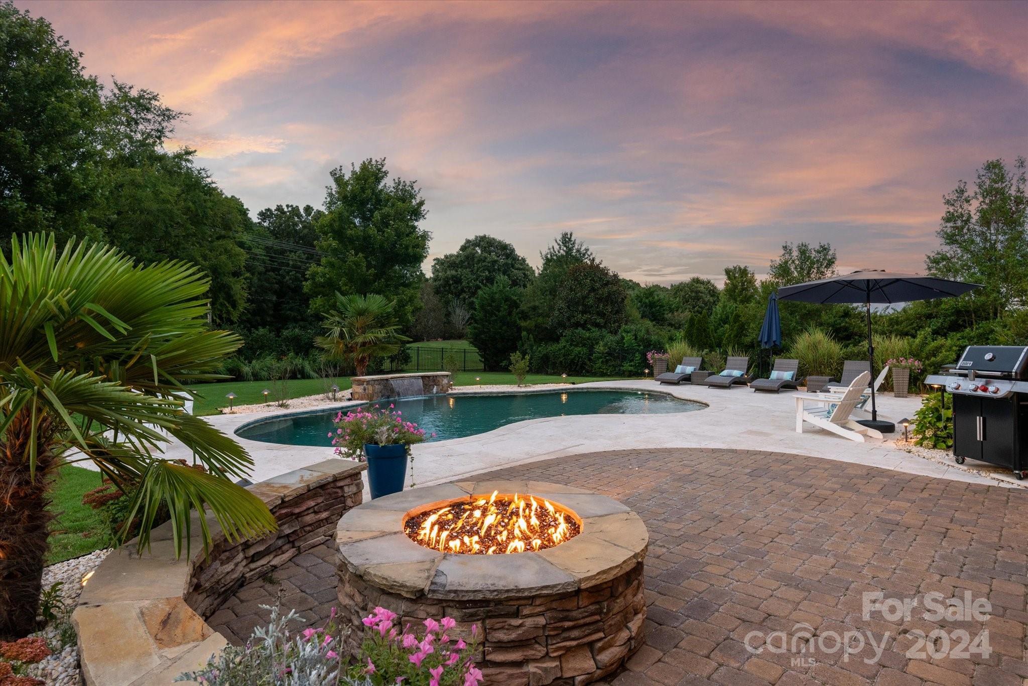 Stunning 5 bed, 4 bath home in the highly desirable Chimneys of Marvin neighborhood. Custom pebbletec saltwater pool with travertine deck, gas fire pit and oversized screened porch in a very private setting to enjoy the outdoors year-round. Completely renovated chef’s kitchen with custom backsplash tile, white cabinetry, center island, gas cooktop and walk in pantry. Open concept with 2 story great room w/fireplace. First floor guest suite with access to a full bath, formal dining and office w/French doors. Double staircase and hardwoods through 1st floor. Beautifully updated 2nd floor primary with spa-like bath to include sitting area, garden tub, walk in closet & large vanities. 3rd bedroom with dedicated bath plus 2 additional bedrooms with full bath complete the 2nd floor. Award winning Marvin Schools. Fantastic amenities include playground, tennis courts, volleyball, zero entry pool w/slide, kiddie pool & walking trails.