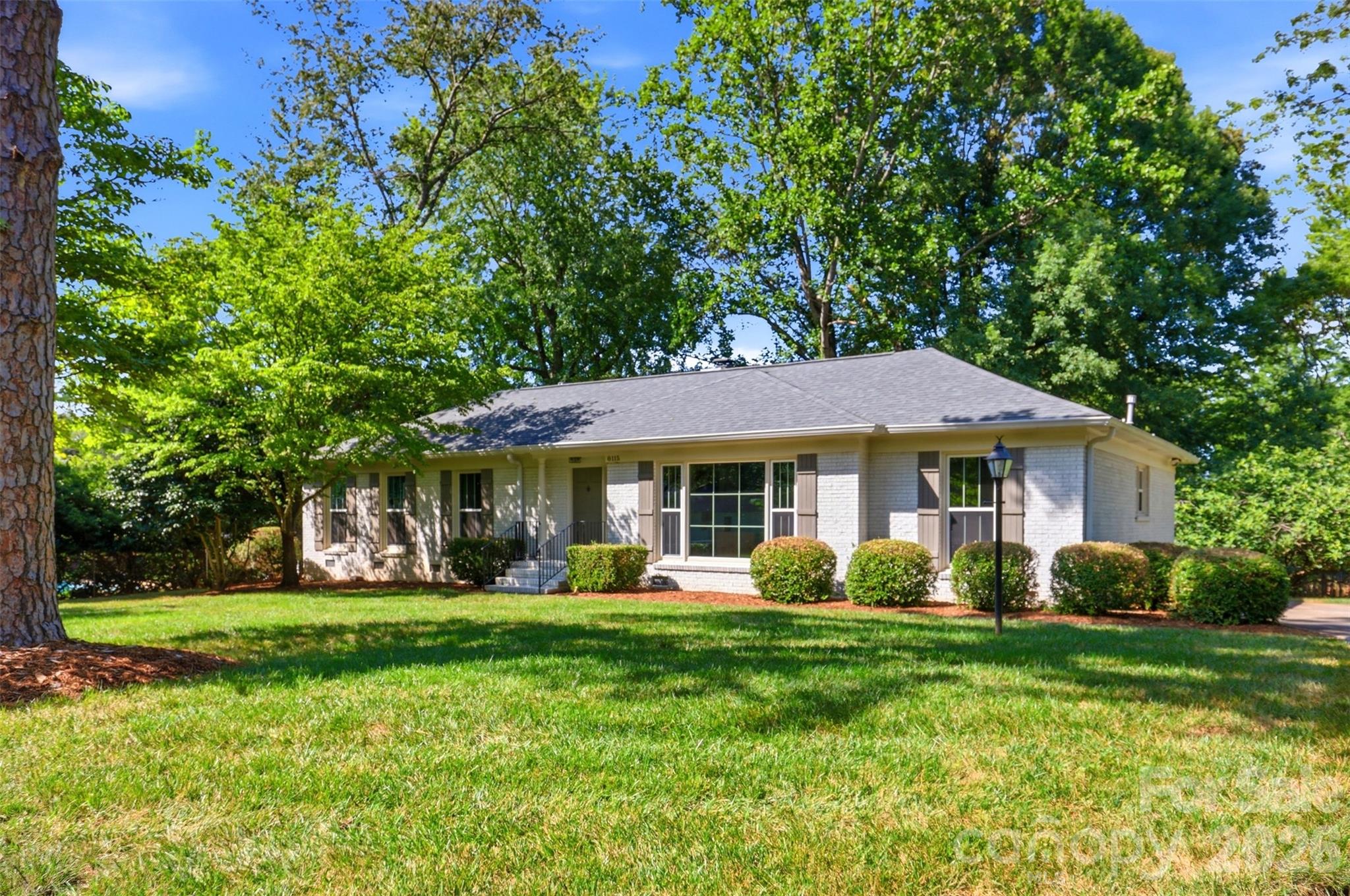 Tucked into the sought-after Olde Heritage neighborhood, this beautifully renovated 3-bedroom, 2-bath brick ranch sits on a perfectly level .39-acre lot. Inside, an open, light-filled floor plan connects generously sized living spaces, anchored by a fully reimagined kitchen featuring custom cabinetry, a 7-foot island with extra storage and seating, quartz countertops, a subway tile backsplash, new stainless steel appliances, and statement globe pendant lighting. French doors lead to a sun-drenched sunroom framed by floor-to-ceiling windows. The primary bath features a frameless glass shower with a designer tile surround and flooring, paired with a retro-inspired vanity and lighting. The guest bath, on the other hand, boasts a double-sink vanity, a new tub, a subway tile surround, and playful blue-and-white patterned floor tile. Hardwood floors run throughout the bedrooms, living, and dining areas, complemented by new craftsman-style interior doors and trim. A brand new HVAC, newer roof, and windows (2022) round out this move-in-ready home. Minutes from top-rated private schools and just a short drive to SouthPark, Cotswold, and The Arboretum for premier shopping, dining, and entertainment.