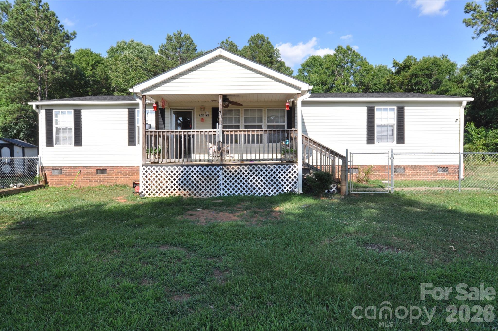 Escape to peaceful country living with this charming 3-bedroom, 2-bath home situated on 2.43 acres in the growing town of Chester! This inviting property offers the perfect blend of comfort, space, and convenience, with an easy commute to both Charlotte and Columbia. Inside, you'll find a spacious kitchen featuring abundant countertop space, making meal preparation and entertaining a breeze. Best of all, all kitchen appliances convey with the home. The primary suite offers a large walk-in closet and a private bath complete with a double vanity, separate shower, and relaxing garden tub. The hall bathroom also provides generous vanity space and a convenient tub/shower combination.  Step outside and enjoy the peaceful surroundings from the covered front porch—an ideal spot to relax with a glass of sweet tea. The chain-link fenced front yard provides a great space for pets or play, while the spacious back deck is ready for grilling, outdoor dining, and gatherings with family and friends. If you're looking for room to spread out, a peaceful country setting, and the convenience of nearby city access, this property is the one.