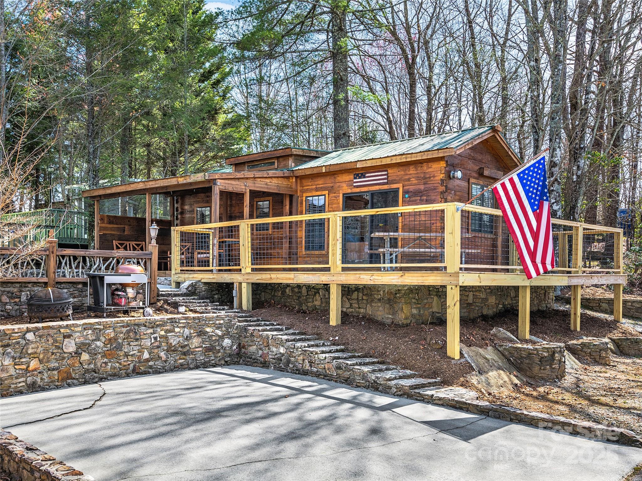 Located in the RV community of Westridge, this furnished, cozy mountain cabin is the perfect getaway! Featuring a 1 bedroom with a king size bed, 1 full bathroom with a stand-up shower, and a loft area with a queen size bed, this is the perfect vacation spot. This site also features an RV pad with hookups! Updates include brand new deck, landscaping, mini split and hardwood flooring throughout. Potential to customize and add a screened-in porch to enjoy during all seasons. Site also features out building for extra storage. Currently set up as a vacation rental with a 2-night minimum stay. Full kitchen equipped with granite counter tops and gas stove. Suitable for Class A Motorcoaches up to 45' with a 50 AMP hook-up. No restrictions on the type of motorcoach allowed. Schedule your showing today!