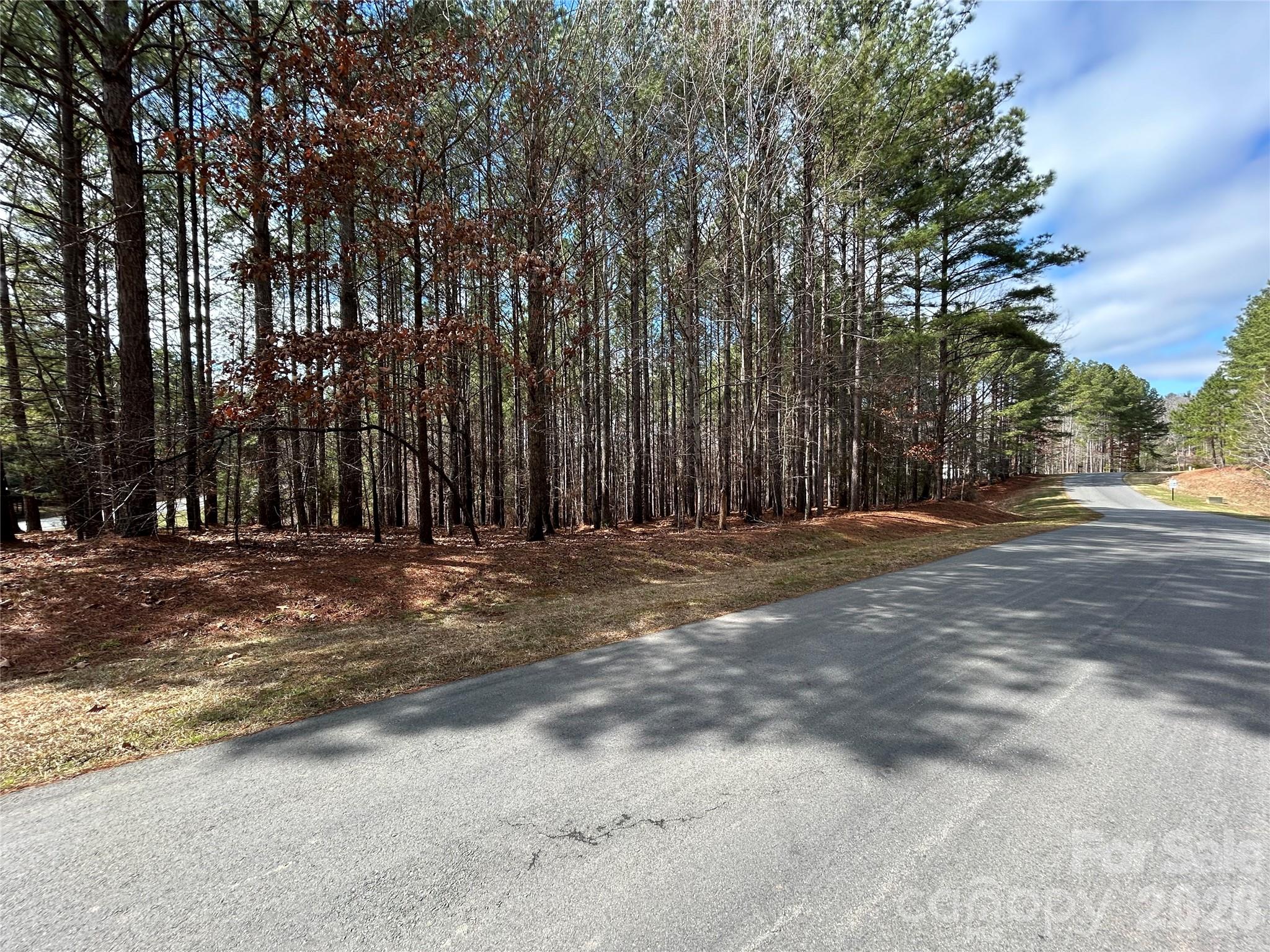 Large mostly wooded corner lot is over 2 acre in the beautiful Swift Island Plantation gated community. County/City water a sewer connections available. Located adjacent to Lake Tillery, a golf course, boating access, and a community storage area for your boat or camper. HOA fees are $925.00 per year. with one time $1.850 capital fee to the HOA. Community covenants and documents available at https://www.casnc.com/communities/swift-island-plantation/
