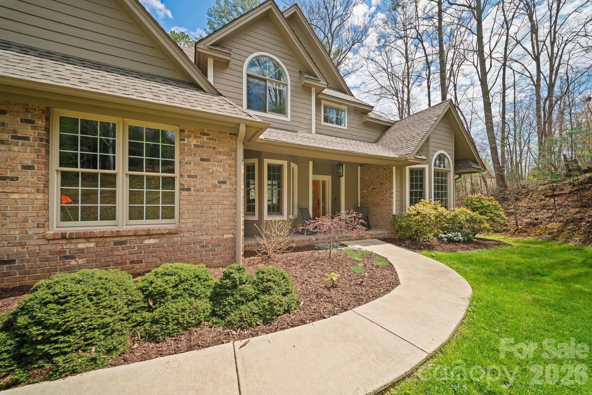 Set in the sought-after Hawks Landing community, this 4-bedroom, 2.5-bath home offers a blend of comfort, space, and seasonal mountain views. The main level features a spacious primary suite, formal dining room, and an inviting living area connected to the eat-in kitchen by a striking two-sided fireplace. Natural light pours through the living spaces, creating a warm and open feel throughout. The fully finished, walkout daylight basement adds valuable flexibility for additional living, entertaining, or workspace. Recent updates include a new roof and HVAC system installed in 2022, offering peace of mind for years to come. Enjoy a quiet setting just 10 minutes from everyday conveniences and only 20 minutes to downtown Asheville’s dining, shopping, and vibrant lifestyle.