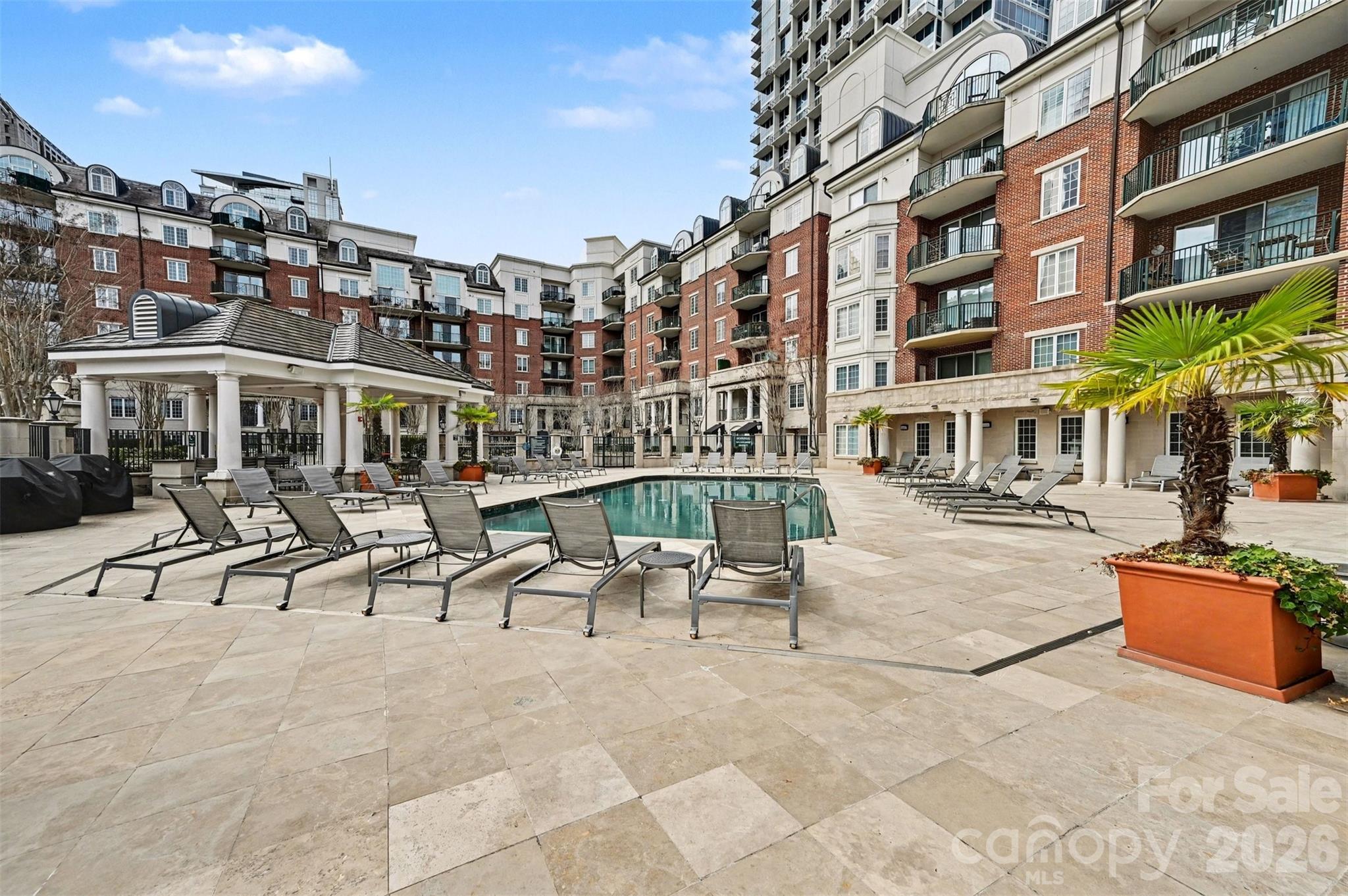 Step into the energy of Uptown Charlotte while enjoying the comfort of a quiet retreat in this beautifully maintained 2-bedroom, 2-full bathroom residence at Fifth & Poplar. From your private balcony, unwind with peaceful courtyard views and subtle glimpses of the Charlotte skyline a rare combination that delivers both city excitement and everyday serenity.

Inside, thoughtful conveniences make city living easy. The unit includes a secured parking space along with a private additional storage area, an uncommon advantage in Uptown that provides valuable extra room for the things you want close by but out of sight.

Life at Fifth & Poplar feels more like a private club than a condominium community. Residents enjoy resort-style amenities including a sparkling pool, fitness center, lounge, game room, private coffee and tea bar, putting green, and secure building access with a 24-hour onsite concierge.

Recent improvements add even more peace of mind, including a new roof installed in 2024, patio resealed and inspected in 2025, a new HVAC system in 2024, and a new water heater in 2023.

And the location? Blocks from Uptown Charlotte’s best dining, entertainment, parks, and cultural attractions giving you the freedom to enjoy everything the city offers while coming home to a space that feels calm, comfortable, and truly yours.