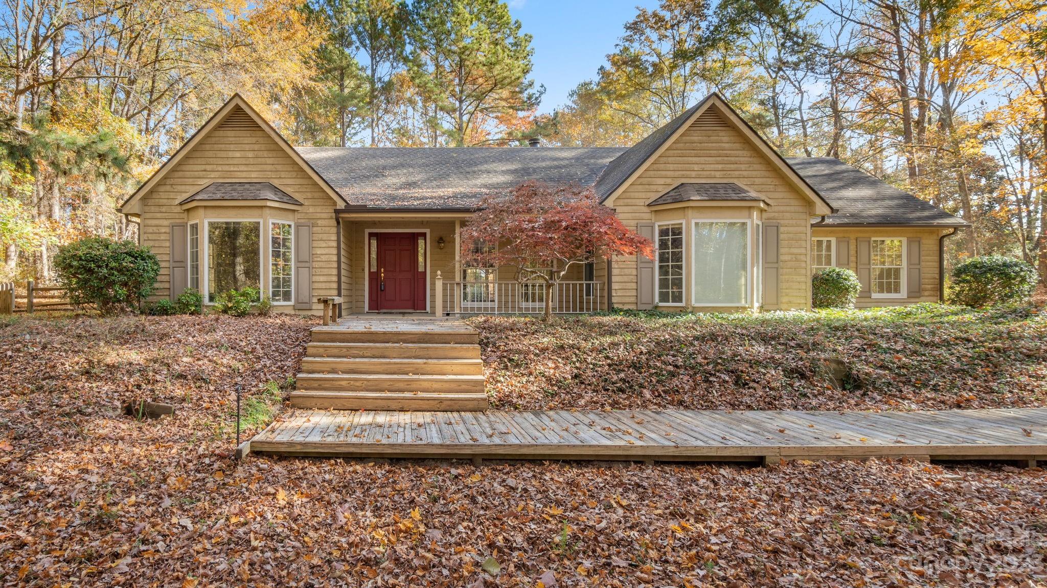 Country Charm - Secluded Feel - City Convenience. This spacious ranch home in the Equestrian Community of Black Horse Run offers all of these. Enjoy the solitude this home offers in a private setting nestled among the trees. When the occasion arises, there's plenty of room to entertain family and friends in the open living area, bonus room w/ wet bar and the screened-in porch. The kitchen has stainless appliances, granite counter tops, an eat-in breakfast area w/ a bay window for enjoying nature along with your morning coffee. The split bedroom floorplan has 3-bdrms/2.5 baths. With 2 acres you can keep the trees and clear/fence some for your own horse. The property has a 16'x24' workshop/storage building, a 24'x24' Lean-to and a 30'x24' concrete pad w/ 30amp RV hook-up and water connection. Black Horse Run Community offers a pool, tennis courts, clubhouse, stables, a riding arena and approximately 6-miles of riding trails. Make this one yours and bring your vision to the country.
