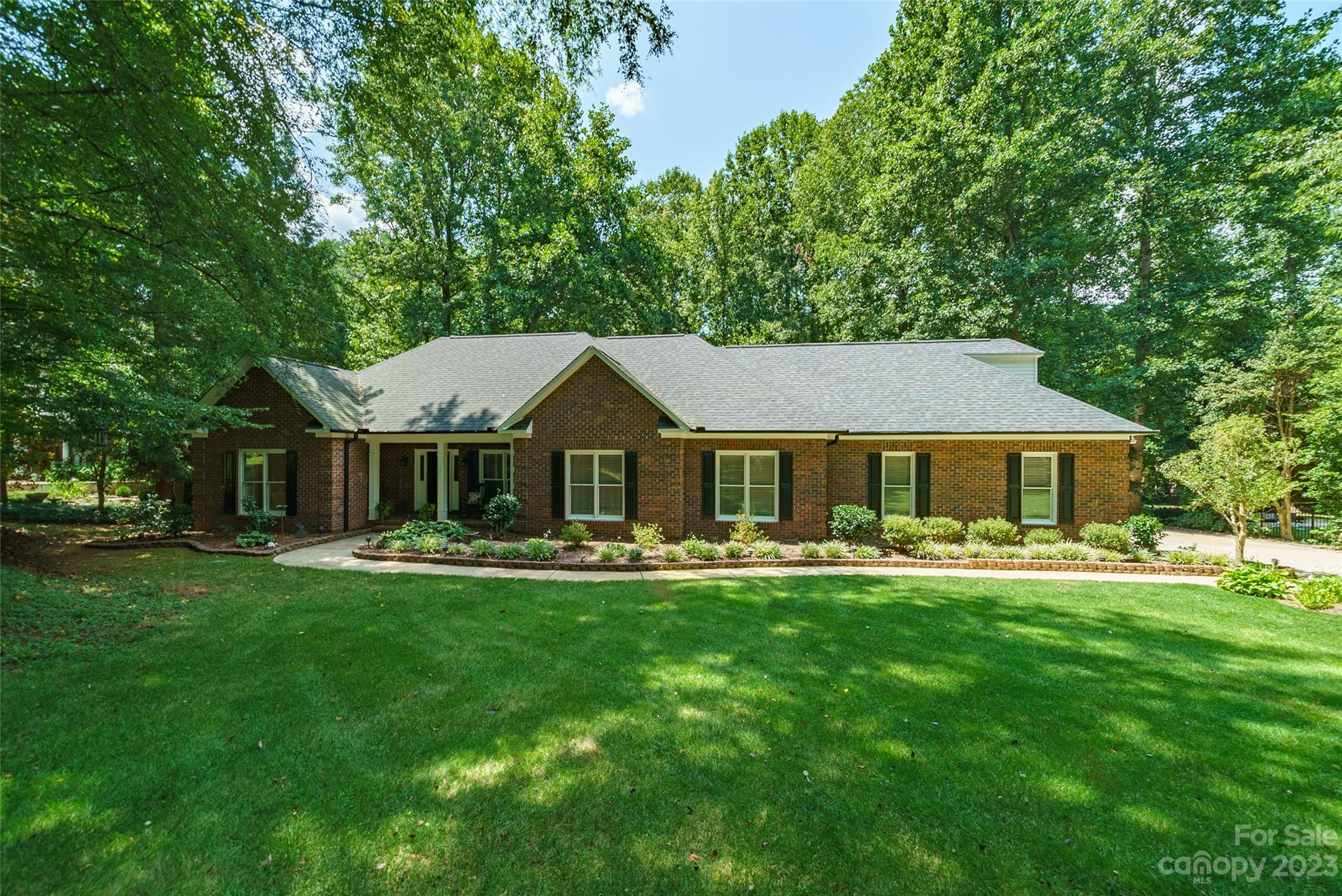 Step into the serenity of this home, nestled on a sprawling 1.24-acre lot adorned with a canopy of mature trees. As you cross the threshold, new vinyl plank flooring guides you through the main areas, creating a seamless connection from the inviting front porch to the heart of the home. Your kitchen awaits, adorned with granite counters & large island breakfast bar – the heartbeat of the home, where conversations flow as easily as meals are prepared. Entertaining is a delight in the open floor plan, where family, dining & kitchen areas converge. The second level reveals a bright & spacious bonus room. Step outside to the tranquil open spaces, where manicured garden beds welcome you home. The yard provides ample room to play, while the ambiance of a mountain retreat pervades the neighborhood's rolling hills. Tucked away in a private cul-de-sac, the location offers a cozy haven just 6.5 miles from Davidson, a charming southern college town boasting shops, restaurants & wide sidewalks.