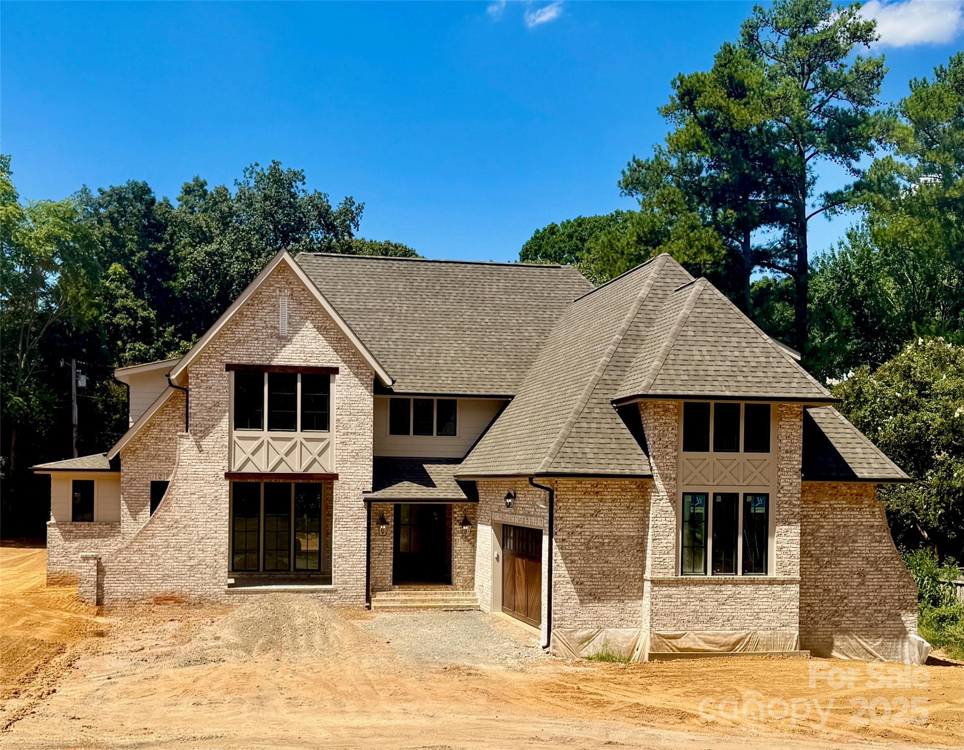 Alenky Signature Home home perfectly situated in desirable S CLT, this custom residence blends timeless design with modern function. Crystal Nagel Design, finishes welcome you as you step inside. The chef’s kitchen features custom cabinetry, a spacious island, professional-grade appliances, & a hidden scullery with a second dishwasher and extra storage, ideal for prep and cleanup. Just off the kitchen, the dining room includes floor-to-ceiling windows, stunning ceiling detail, and a butler's pantry with built-in bar, wine fridge, and ice maker. The great room centers around a cast stone fireplace flanked by custom-built-ins, and glass sliders open to a covered porch for effortless indoor-outdoor living. The main-level primary suite overlooks the backyard and features a spa-inspired bath and walk-in closet with laundry hookups for added convenience. Upstairs, you’ll find three additional bedrooms- each with an ensuite bath, a 2nd laundry room, and open loft space. Welcome home!