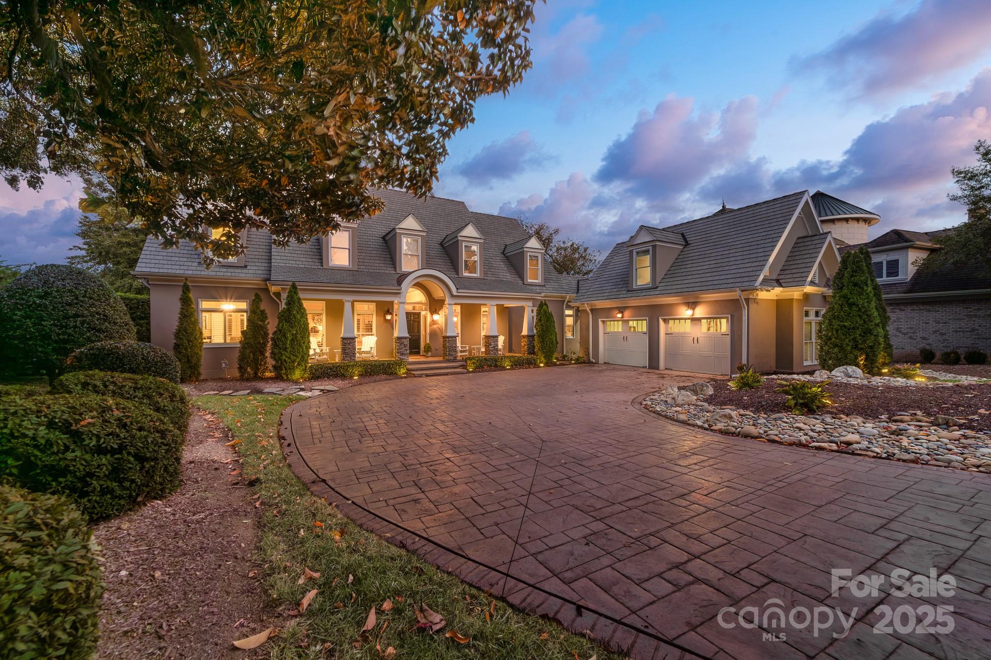 Refined waterfront living in The Peninsula—where architectural detail, thoughtful renovation,  
and everyday lake life meet. This exceptional home presents an unforgettable lakeside 
experience. A long stamped-and-stained approach and classic lantern lighting welcome guests to 
a residence defined by premium finishes and a seamless indoor-outdoor flow, featuring a covered 
front porch that spans nearly the entire length of the home.  Inside, exceptional millwork, crown molding, and custom built-ins reveal a home carefully curated for both entertaining and relaxation. The completely renovated kitchen—anchored by exotic Brazilian granite, a hammered copper sink, Wolf cooktop, double ovens, and expansive pantry—flows directly into the family room and onto the large covered back deck. Oversized 
picture windows and plantation shutters frame the lake at every turn, bathing rooms in light and 
drawing the eye to the water beyond. The main-floor primary suite is a true lakeside retreat with private deck access, dual custom walk-in closets, and a spa-inspired bath finished in Calacatta marble. Upstairs, guest 
accommodations are generous in scale. Two large bedrooms sharing a thoughtfully designed 
Jack-and-Jill bath with separate vanities and a stunning walk-in tile shower with glass enclosure, 
plus a third suite with its own ensuite and walk-in cedar closet. A substantial upper-level office 
above the garage, appointed with custom cabinetry and plumbing for a full bath, offers flexible 
workspace or guest accommodations. Heated floors in primary bath. Custom in wall audio system throughout the entire first floor (sunroom, living room, kitchen, bedroom) , great for entertaining  Outdoors, a broad covered deck with beadboard ceiling, recessed lighting, and fans create an ideal setting for morning coffee or sunset entertaining. Flagstone walkways lead to a private 
sandy beach, dock, and firepit, creating multiple lakeside moments to savor. Custom DaVinci composite cedar shingle 50 year roof. This is Lake Norman living at its most elevated—beautifully updated, impeccably appointed, and privately set on one of The Peninsula’s most desirable stretches of shoreline. Opportunities of this quality are rare.