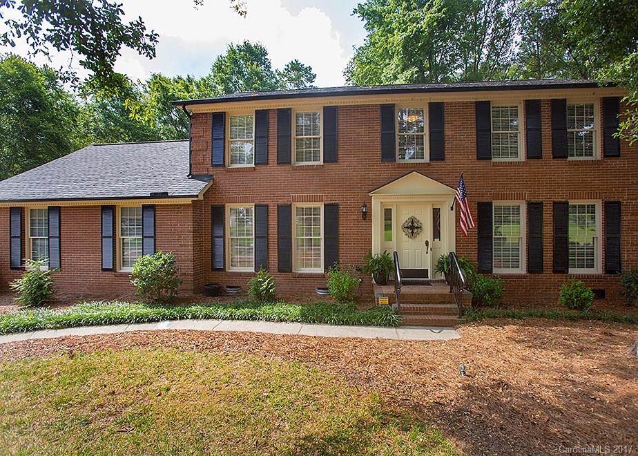 Classic custom built brick home in highly desirable award winning school district of Fort Mill. Large kitchen w/granite counter tops. Custom cabinet w/under cabinet lighting. Den has fireplace and custom crafted bookcases, large deck w/maintained yard backing into the woods. Crown mold on ceilings, pocket doors, specialty lighting fixtures in the kitchen, Large Bonus room over the 2 car garage, which has a workshop. Seller is including a 1 year home warranty to buyer!