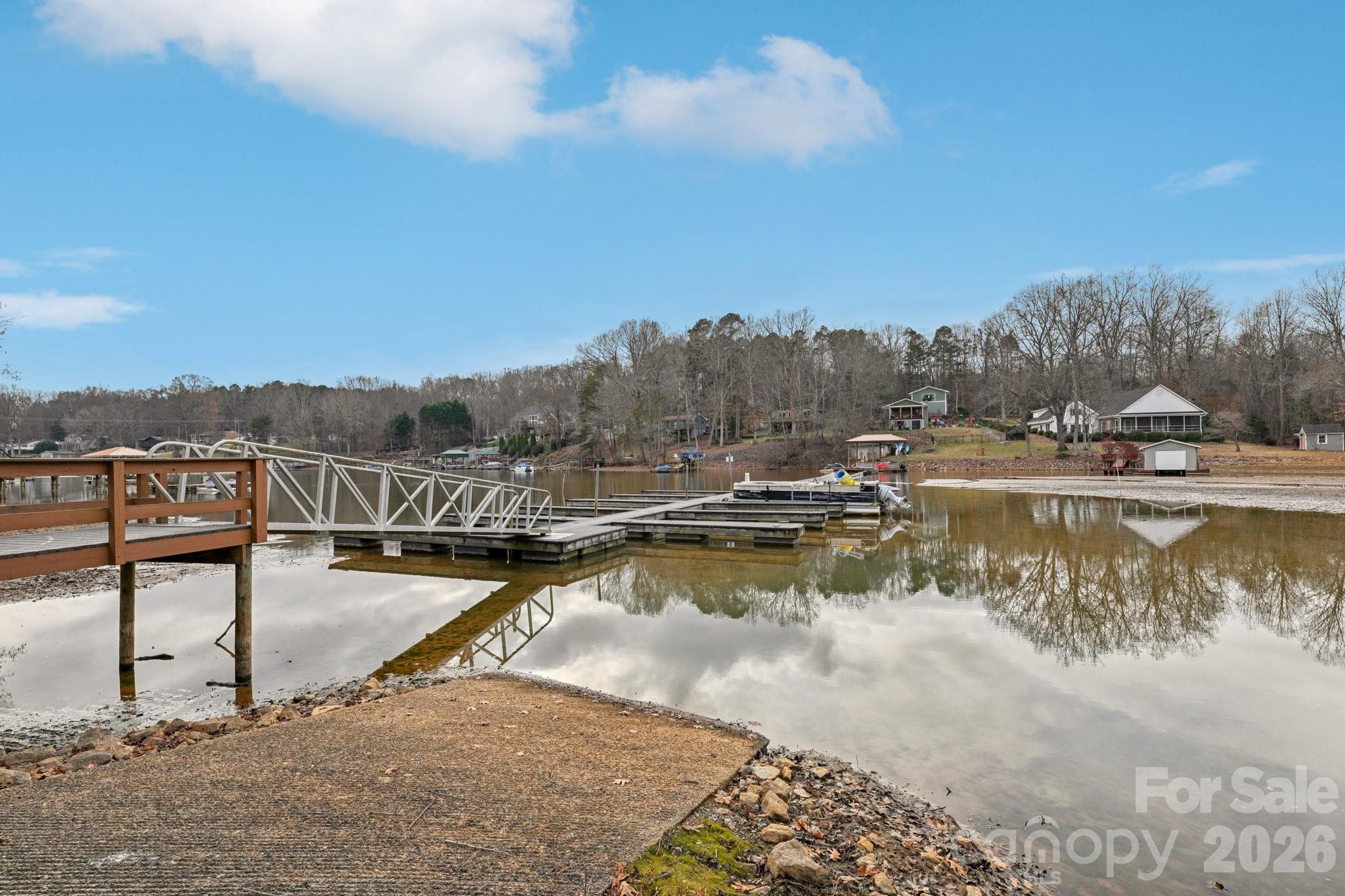 Lake Norman access for under $450,000! Welcome to this charming home in The Retreat, one of Sherrills Ford's most desirable Lake Norman Communities. Residents enjoy lake access, a community boat launch, and a community dock - perfect for embracing the lake lifestyle. Boatslips are available for $350 annually through a lottery system, and 5 slips are currently still available for this year. This property sits on nearly 3/4 of an acre, offering privacy and a peaceful wooded backdrop. A spacious rear deck provides the ideal outdoor setting for relaxing, grilling, or entertaining. Inside, the home has been freshly painted and features a warm and inviting gas fireplace in the living area. The dining room includes hardwood floors, adding a touch of elegance to everyday living. The primary suite offers its own ensuite bath, while a secondary bedroom is enhanced by an attached bonus room, giving you the flexibility for a home office, playroom, fitness area, or guest space. This home combines generous indoor and outdoor living spaces with lake access amenities and the peaceful setting The Retreat is known for, making it an excellent opportunity for anyone seeking the Lake Norman lifestyle.