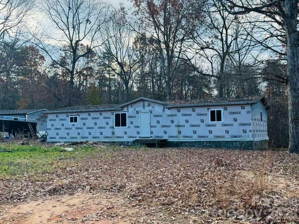 Investor or renovation opportunity! This unfinished double-wide manufactured home offers a spacious layout designed for 4 bedrooms and 3 full bathrooms. The exterior framing, house wrap, windows, and roof are in place, while the interior remains unfinished and ready for completion.

Situated on approximately 0.68 acres, the property offers a wooded setting with privacy and plenty of outdoor space. This is an excellent opportunity for a buyer, builder, or investor to customize the home with their preferred finishes and design. Property is being sold as-is. Buyer and buyer’s agent should verify all permits, utilities, completion requirements, square footage, and financing eligibility. Bring your vision and transform this property into a beautiful, finished home!