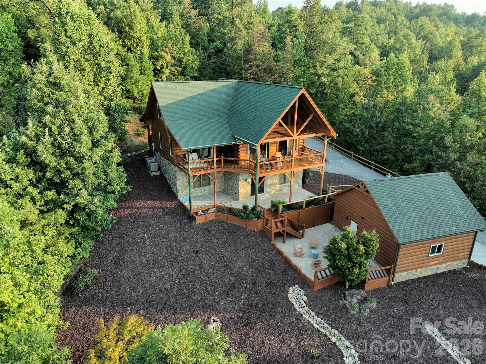 Come home to this pristine and immaculate mountain cabin in the beautiful Grandview Peaks subdivision with stunning, tall ceilings, abundant window light, and amazing views! Enjoy your morning coffee and serenading song birds in this peaceful mountain setting on the large covered deck overlooking the Blue Ridge. The main level features a large kitchen and breakfast bar, family room and fireplace and a master bedroom with walk-in closet and access to its own private porch. There is an additional half bath on the main level. The upper level features two bedrooms, a shared full bath, and a loft area for relaxing. The newly finished walkout basement features a recreation room, wine bar with two wine coolers, a full bath and a family room with a second fire place. There is an additional bonus room, currently used as a 4th bedroom. The laundry is also in the basement.  Stepping out of the basement from the family room takes you to another parking area. Walking out the back basement sliding glass door takes you another porch and a 220 wired hot tub pad, and down to the fire pit area and two-car garage, currently being used as a game room. The Grandview Peaks subdivision is a gated community with hiking trails, private stocked lake, white sandy beaches, covered pavilion, picnic area, and dedicated space for a variety of yard games. This beautiful property comes fully furnished. Owner is a licensed NC agent.