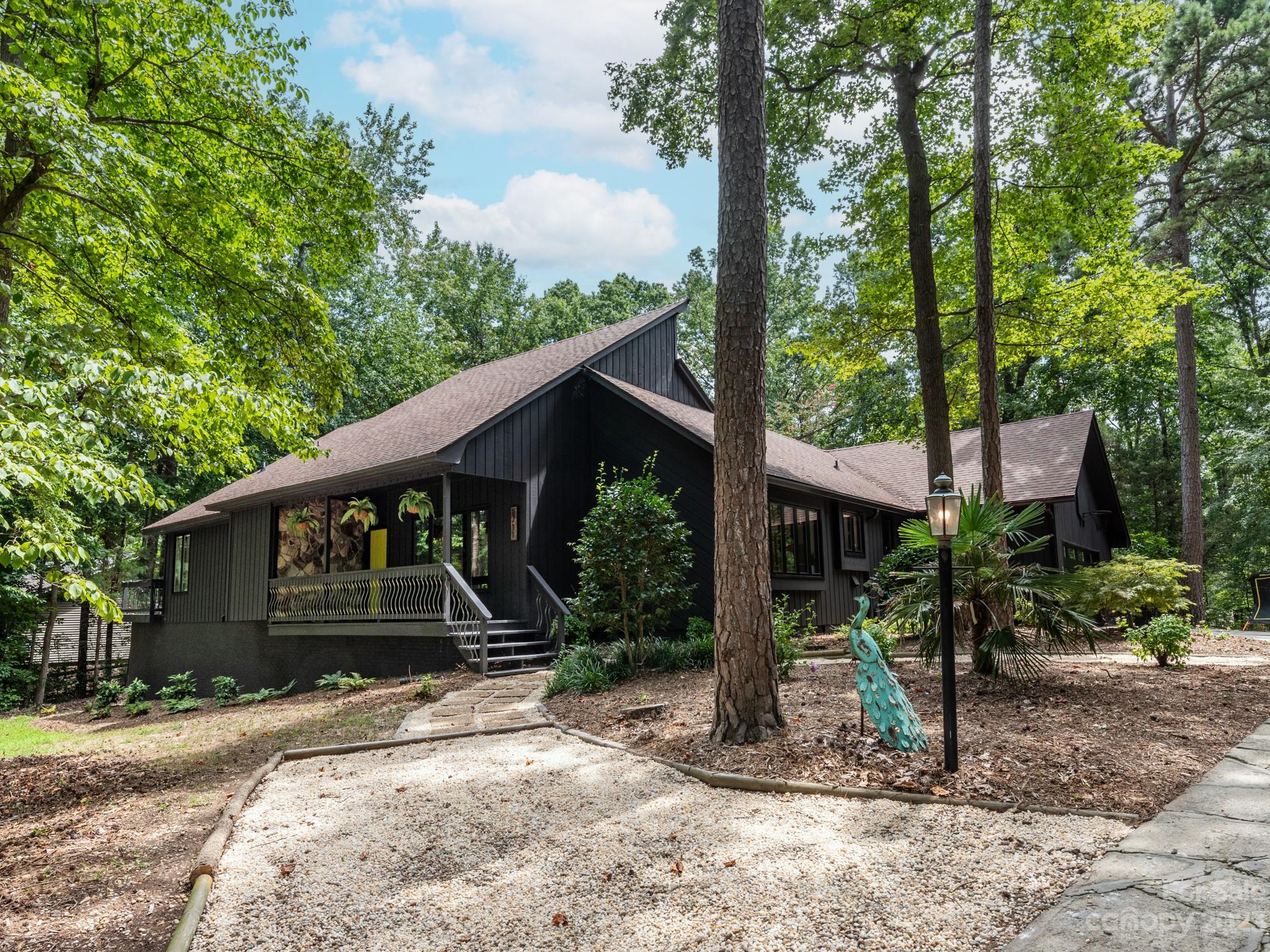 This contemporary and unique custom home will feel like you are escaping to your mountain retreat every time you come home! Desirable Beech Bluff neighborhood with no HOA and Cox Mill Schools. This home has been completely modernized throughout to include all new floors, paint, smooth ceilings, recessed lighting, new fixtures, updated kitchen with quartz countertops and beautifully fun bathrooms! The open great room with soaring ceilings, a gorgeous stone gas log fireplace and incredible views of the backyard and trees has been the favorite place to relax. If you're looking for flex space, this home has many options with the upstairs loft and basement recreation area with workshop. No shortage of storage with 2 large walk-in attics and an additional large storage closet in the garage with access to the backyard. Outside, the huge deck is the perfect place to relax or entertain.