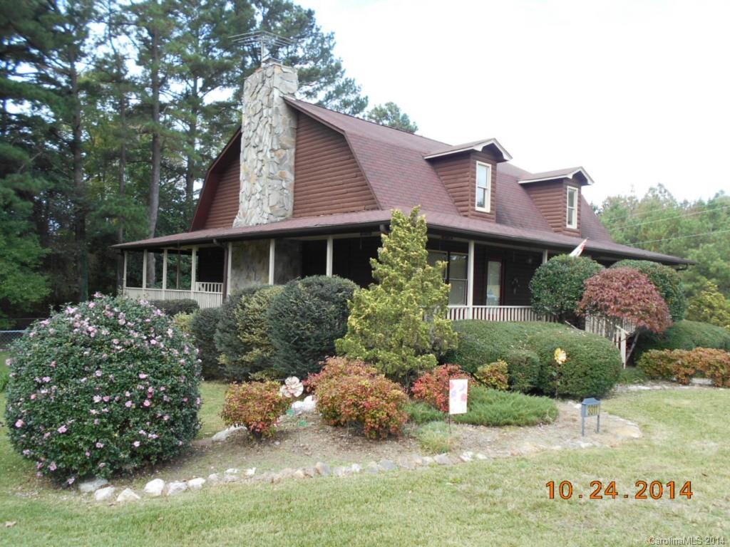 Gorgeous Log Home in a beautiful setting on 4.5 acres. Privacy on all sides. 5 minutes from I-77..Wrap around covered porch. In ground pool and fenced back yard. Soaring ceilings with exposed beams. Stone fireplace, hardwood floors on main level. Skylights, country kitchen with bay window, large laundry room with cabinets, sink and countertops. AC condensing unit for first level only 2 yrs old. Upstairs unit rebuilt in 2012. Master bathroom has double sinks. You won't want to leave.