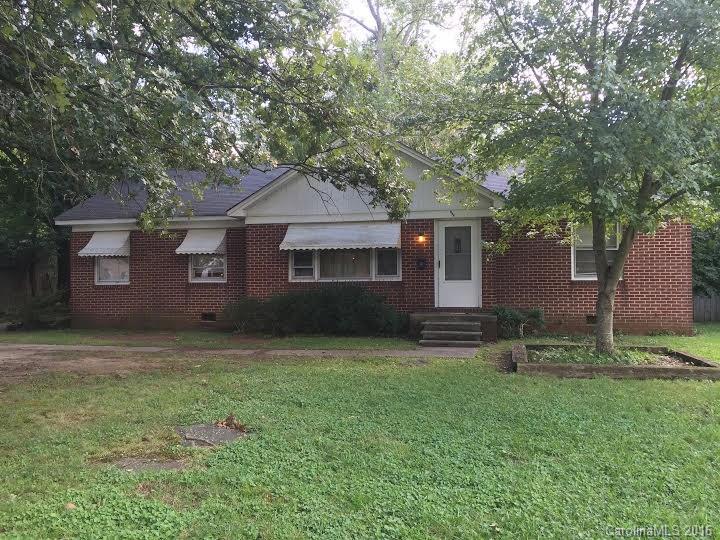 Lovely full brick home with original hardwood floors, screened back porch opens to large back yard