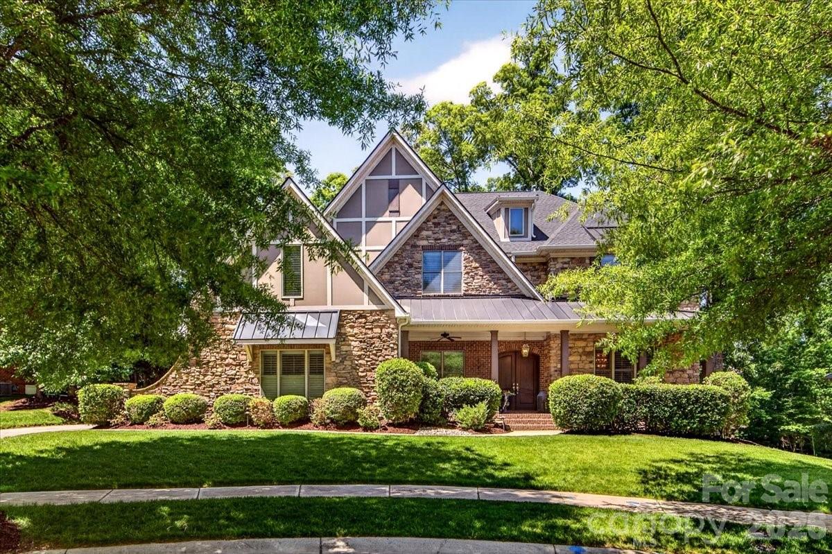 Nestled on a tree lined cul-de-sac, 2702 Cecily Court is an exceptional residence offering over 5,100 square feet of refined living space designed for both elegant entertaining and comfortable everyday living. With timeless stone and brick architecture, sophisticated designer finishes, extensive recent updates and attention to detail throughout, this home offers the perfect balance of luxury, warmth, and functionality.

A welcoming covered front porch and impressive double entry doors lead into a dramatic two story foyer featuring rich hardwood floors, beautiful millwork, fresh interior paint, and soaring ceilings that immediately set the tone for the home’s elevated design. Just off the entry, a dedicated office with French doors and large windows creates an ideal work from home retreat, while the formal dining room impresses with statement lighting, custom wall treatments, detailed trim work, and its own elegant fireplace.

At the heart of the home, the chef’s kitchen was designed with both beauty and practicality in mind. Highlights include a grand center island, multiple prep and serving spaces, abundant cabinetry, updated lighting and a butler’s pantry connecting seamlessly to the dining room. The adjoining living room showcases coffered ceilings, plantation shutters, and a striking stone fireplace.

A main level guest suite with private bath offers ideal accommodations for visitors or multi-generational living. Upstairs, the luxurious primary suite features a private sitting area, spa inspired bath with oversized shower, and dual walk in closets. Additional secondary bedrooms, including an ensuite, and an oversized vaulted bonus room provide incredible flexibility for recreation, media, fitness, or play.

Extensive improvements including a new roof, upgraded gutters and downspouts, refreshed exterior paint, landscape uplighting, newer appliances, updated fixtures, and a new water heater further enhance the home’s move in ready appeal. Residents also enjoy resort style community amenities including a clubhouse, pool, tennis courts, playground, and walking trails.

Elegant, inviting, and thoughtfully designed at every turn, this exceptional home offers a rare opportunity in one of Union County’s most desirable communities.
